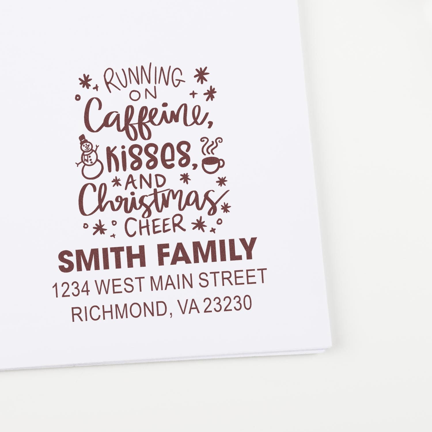 Custom Christmas return address rubber stamp reading Running on caffeine, kisses, and Christmas cheer for Smith family