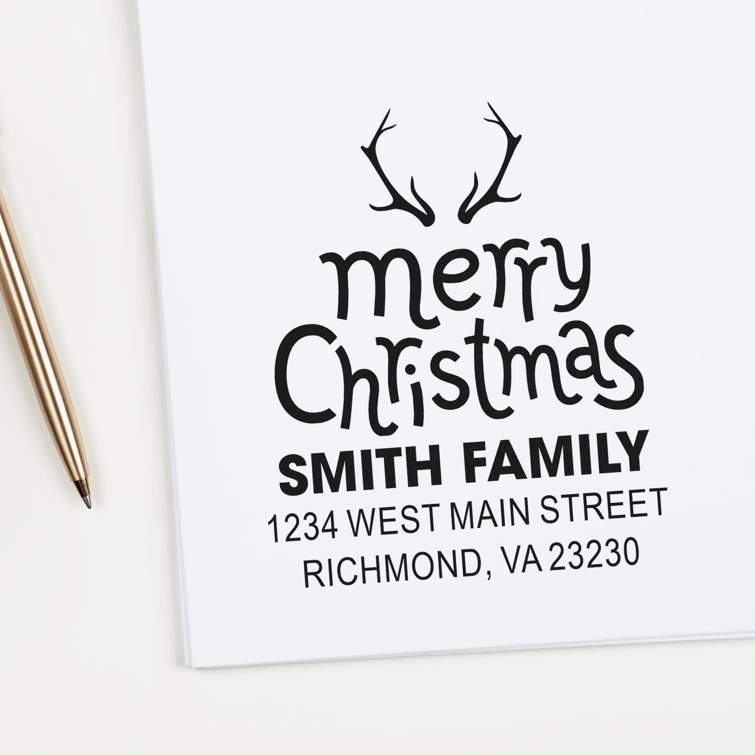 Custom Merry Christmas rubber stamp with antlers, Smith family name, and return address for holiday cards.