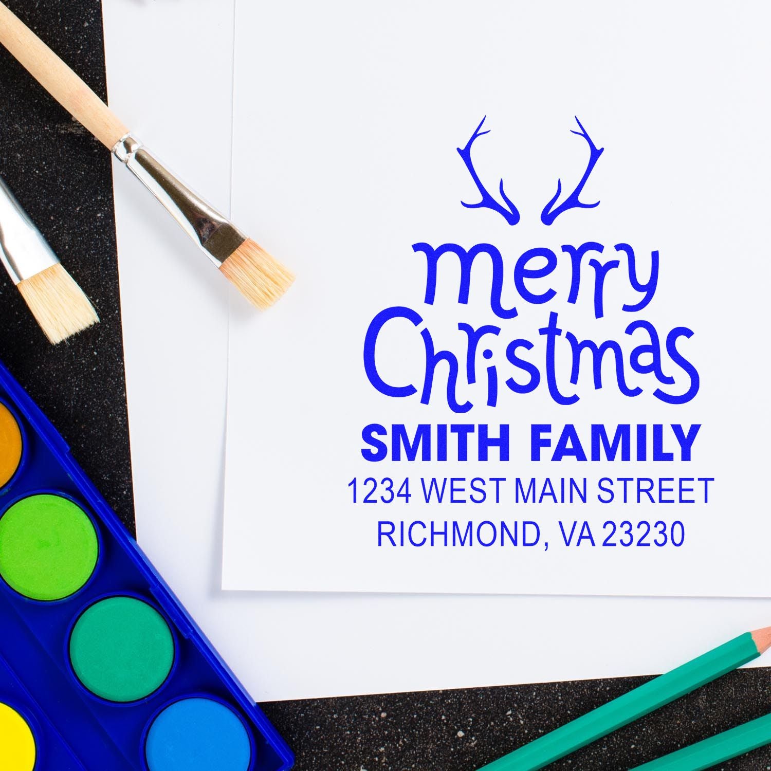 Personalized Merry Christmas rubber stamp with antlers, family name, and return address for holiday cards.