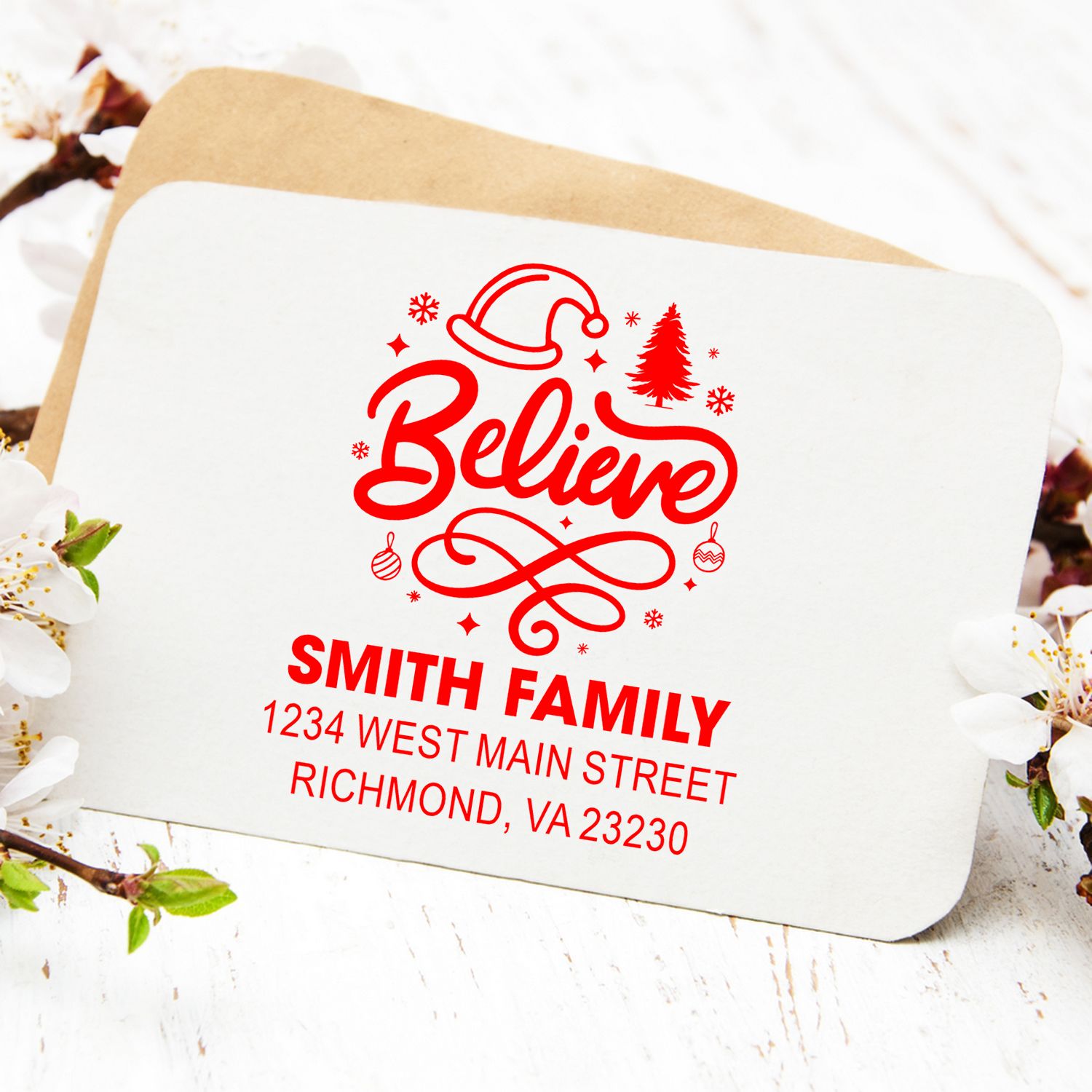 Custom Christmas return address rubber stamp with Believe design, Santa hat, and Smith Family holiday mailing address.