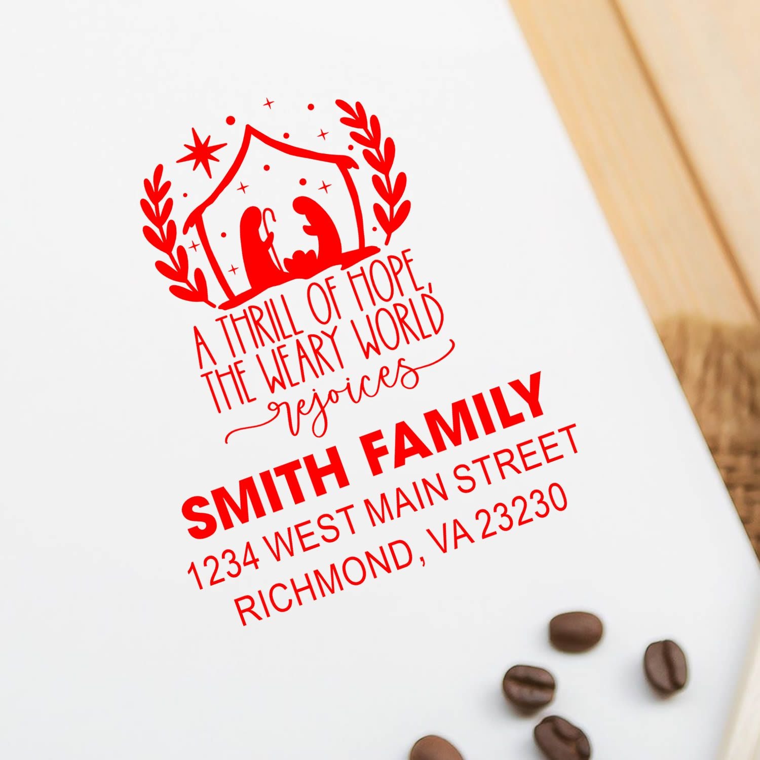 Custom address rubber stamp with family name, street address, and festive holiday wreath design for personalized stationery.