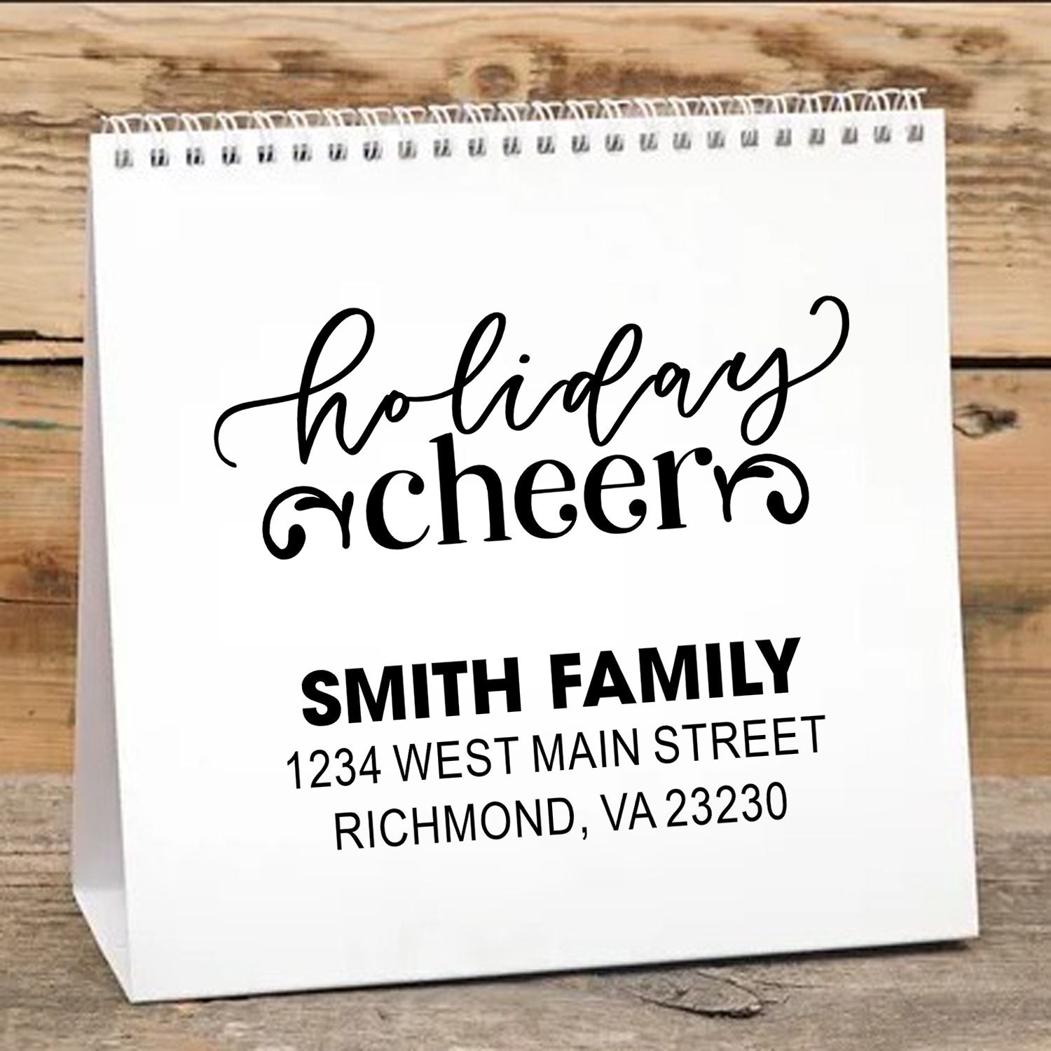 Custom holiday cheer rubber stamp with family name and address for personalized gift bags, cards, and holiday packaging.