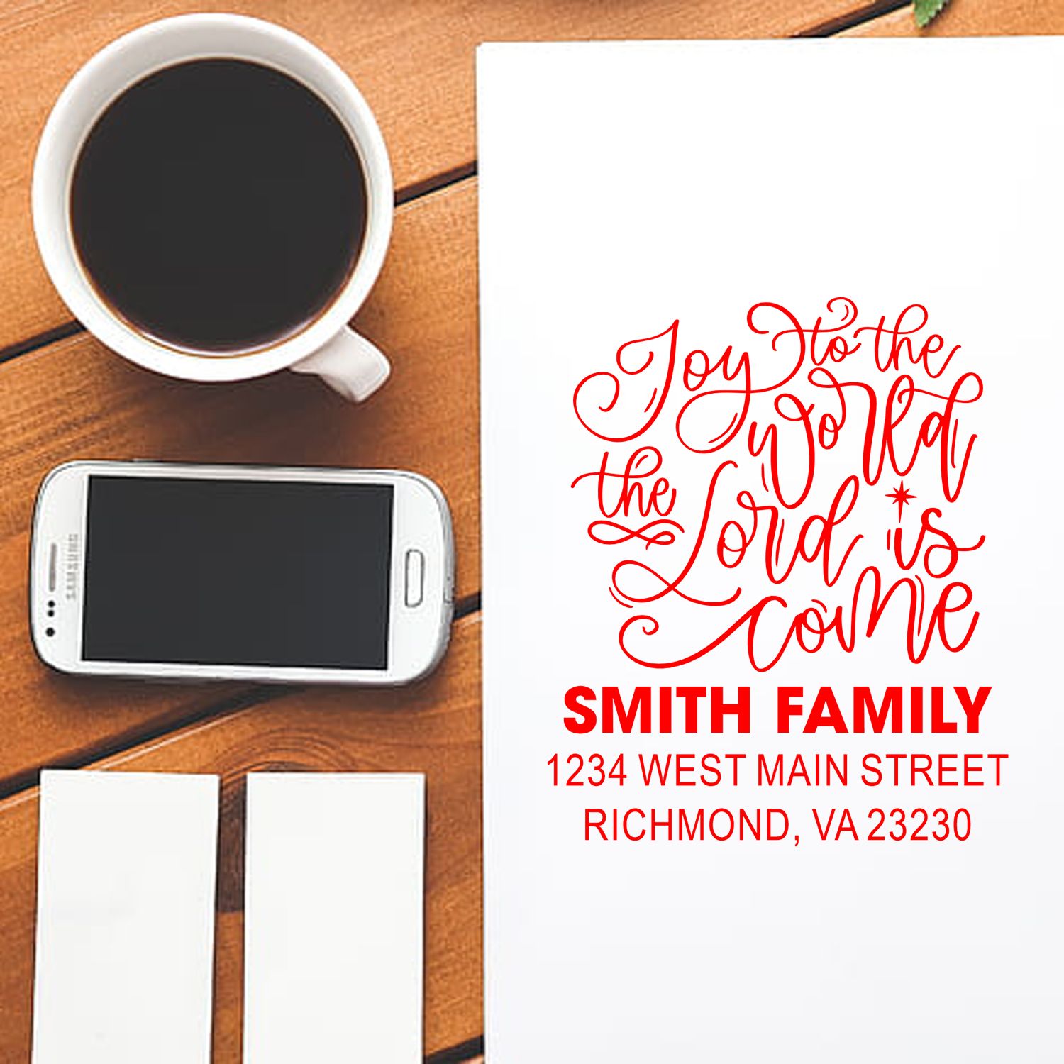 Personalized holiday address rubber stamp mockup with Joy to the World script, Smith Family name, and return address.