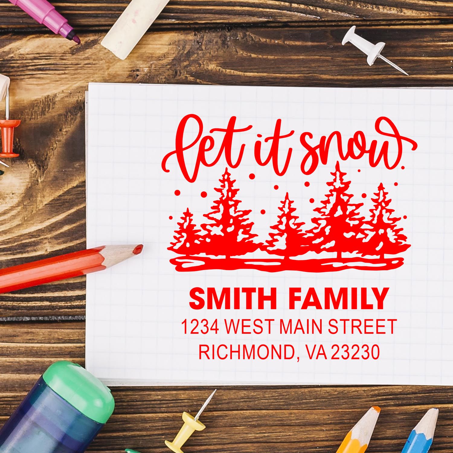 Custom holiday rubber stamp design with Let it snow script, pine trees, and Smith family address for Christmas cards.