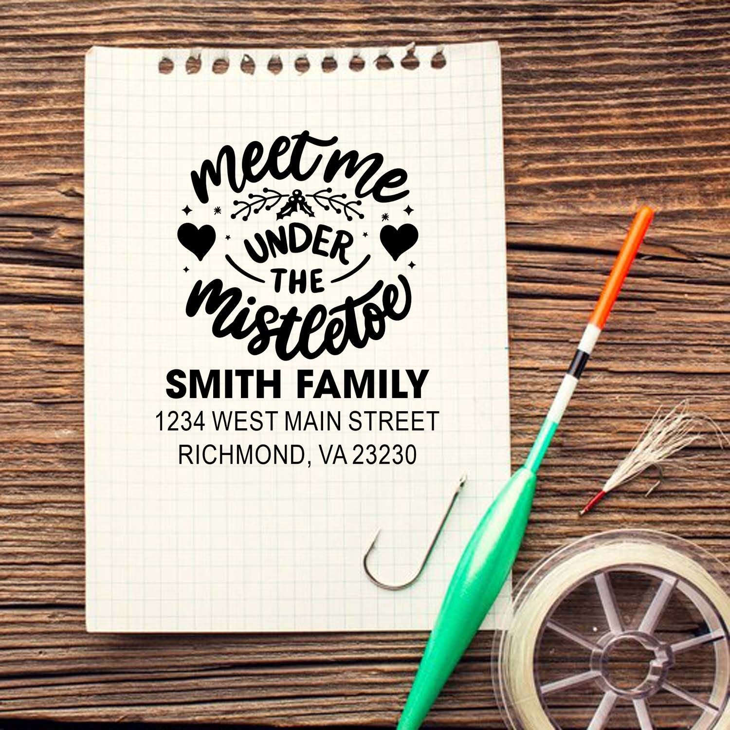 Custom rubber stamp design with Meet Me Under the Mistletoe and Smith Family address for holiday stationery.