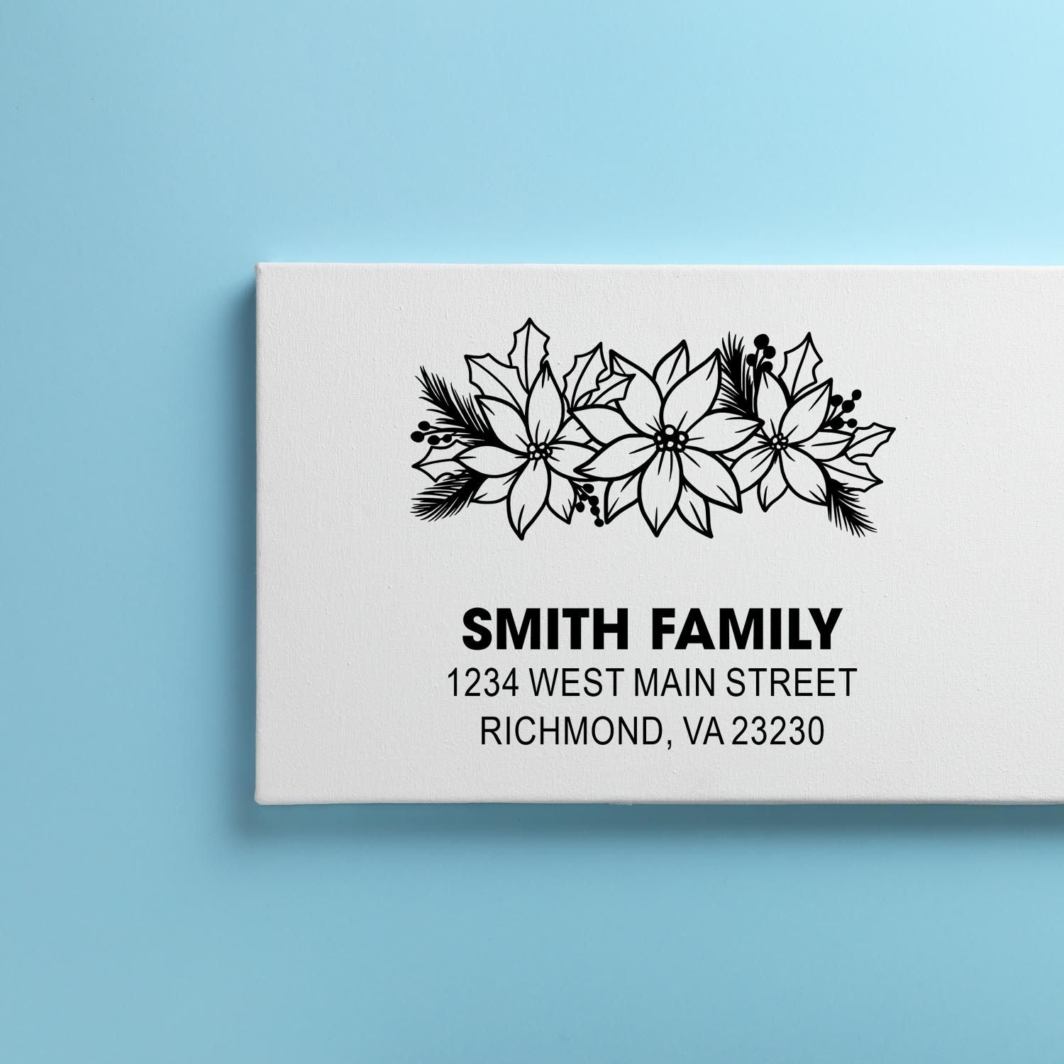 Custom family return address rubber stamp with floral poinsettia design and Smith family address for envelopes and holiday mail.