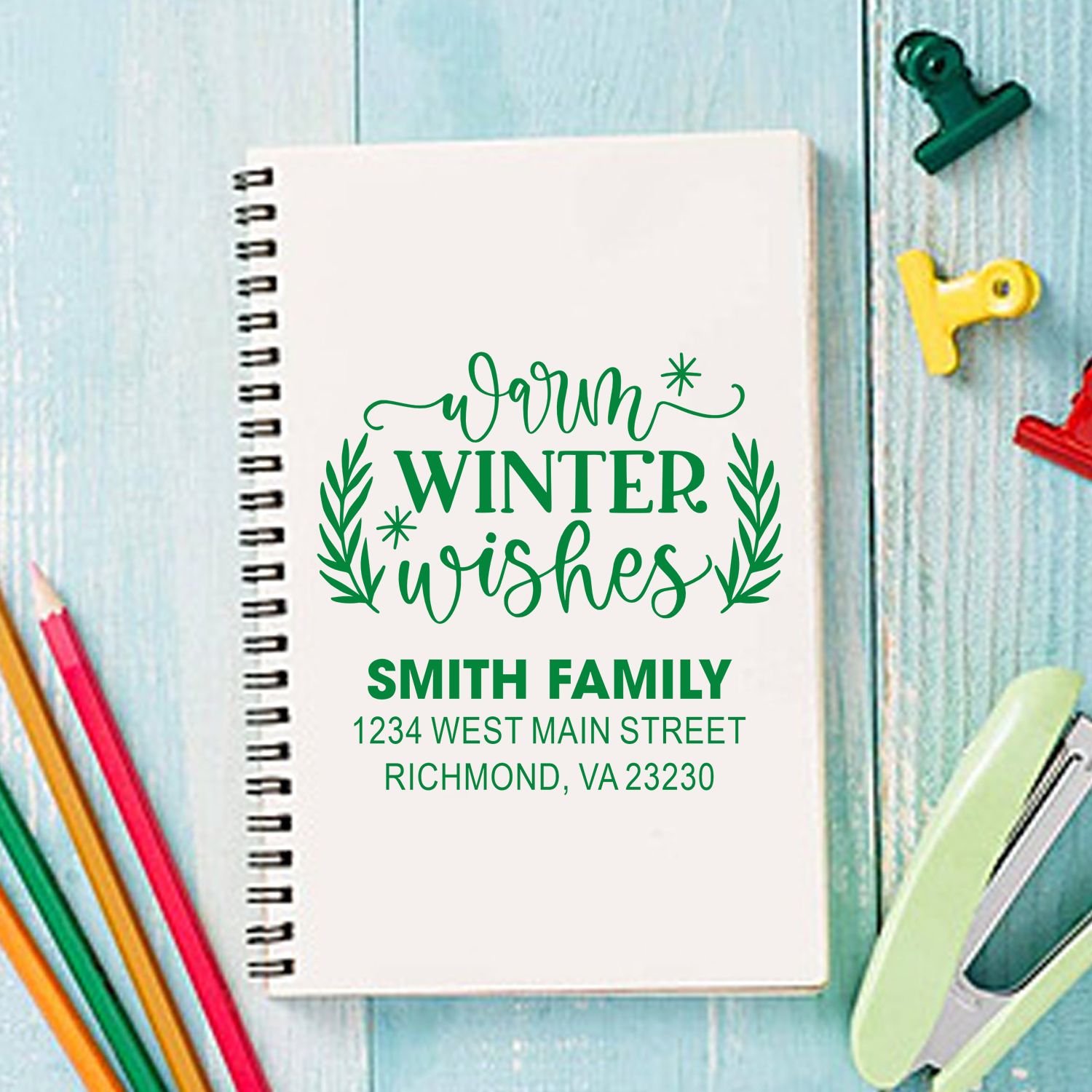 Custom holiday rubber stamp with Warm Winter Wishes, Smith family name, and address on notebook mockup