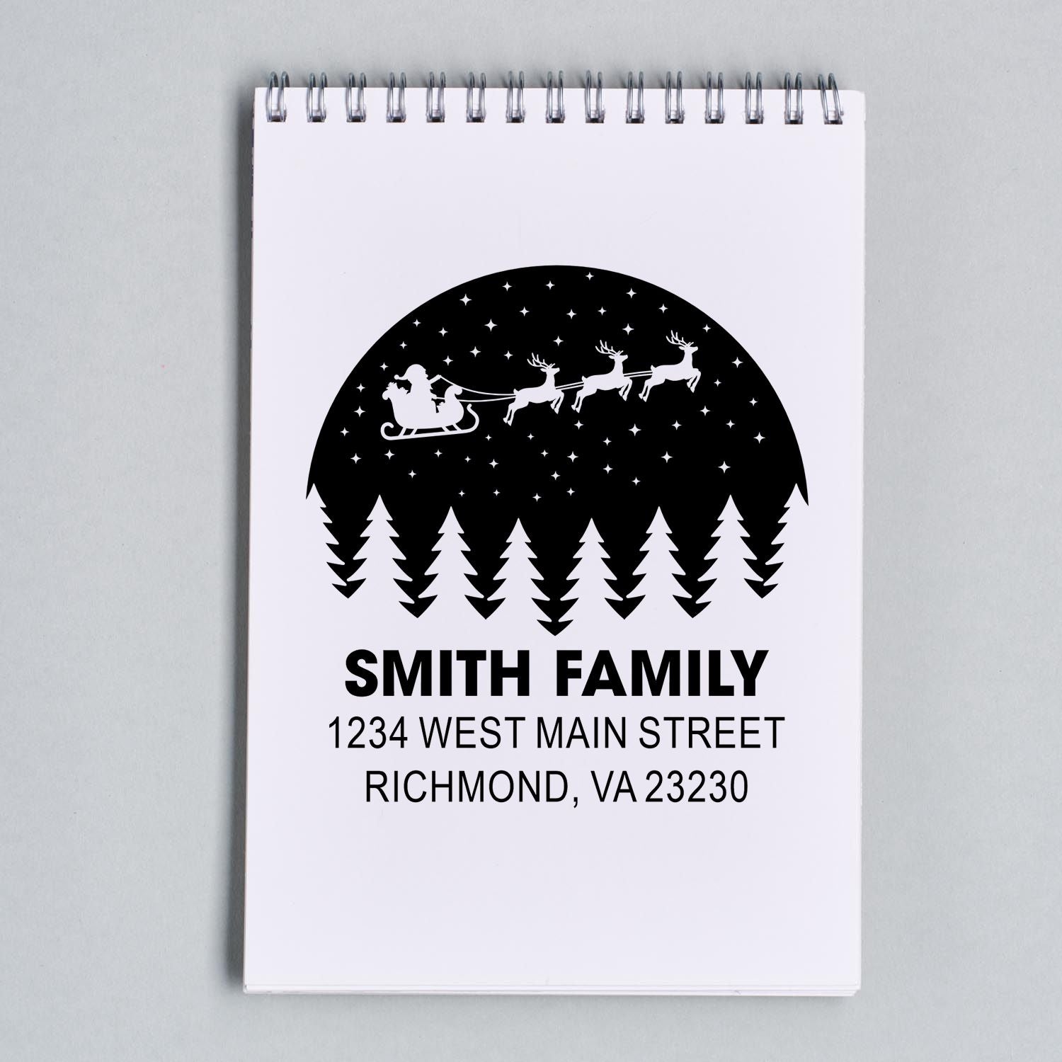 Custom return address rubber stamp with Santa sleigh, reindeer, and pine trees for the Smith family.