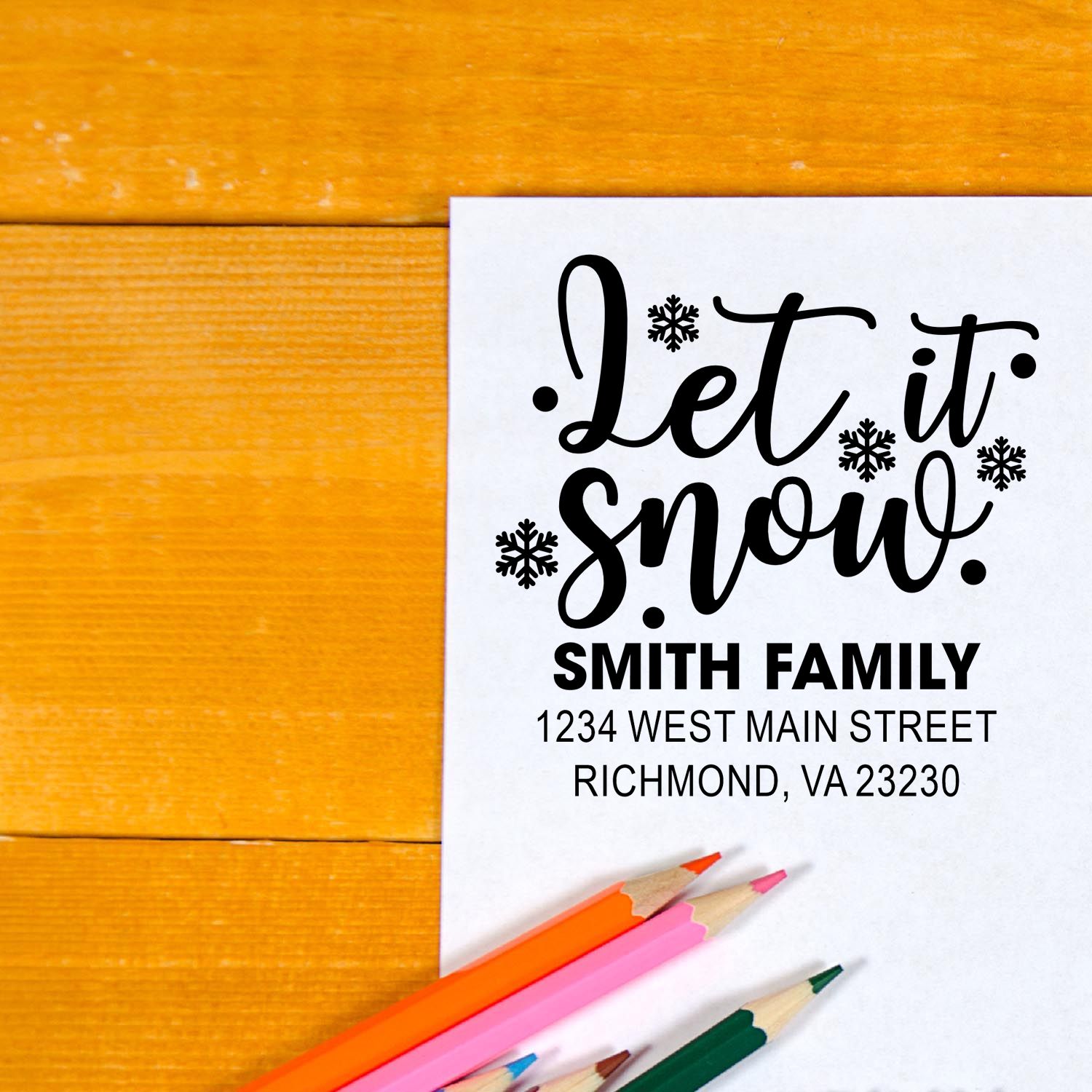 Holiday return address rubber stamp with Let It Snow design, snowflakes, and custom family address.