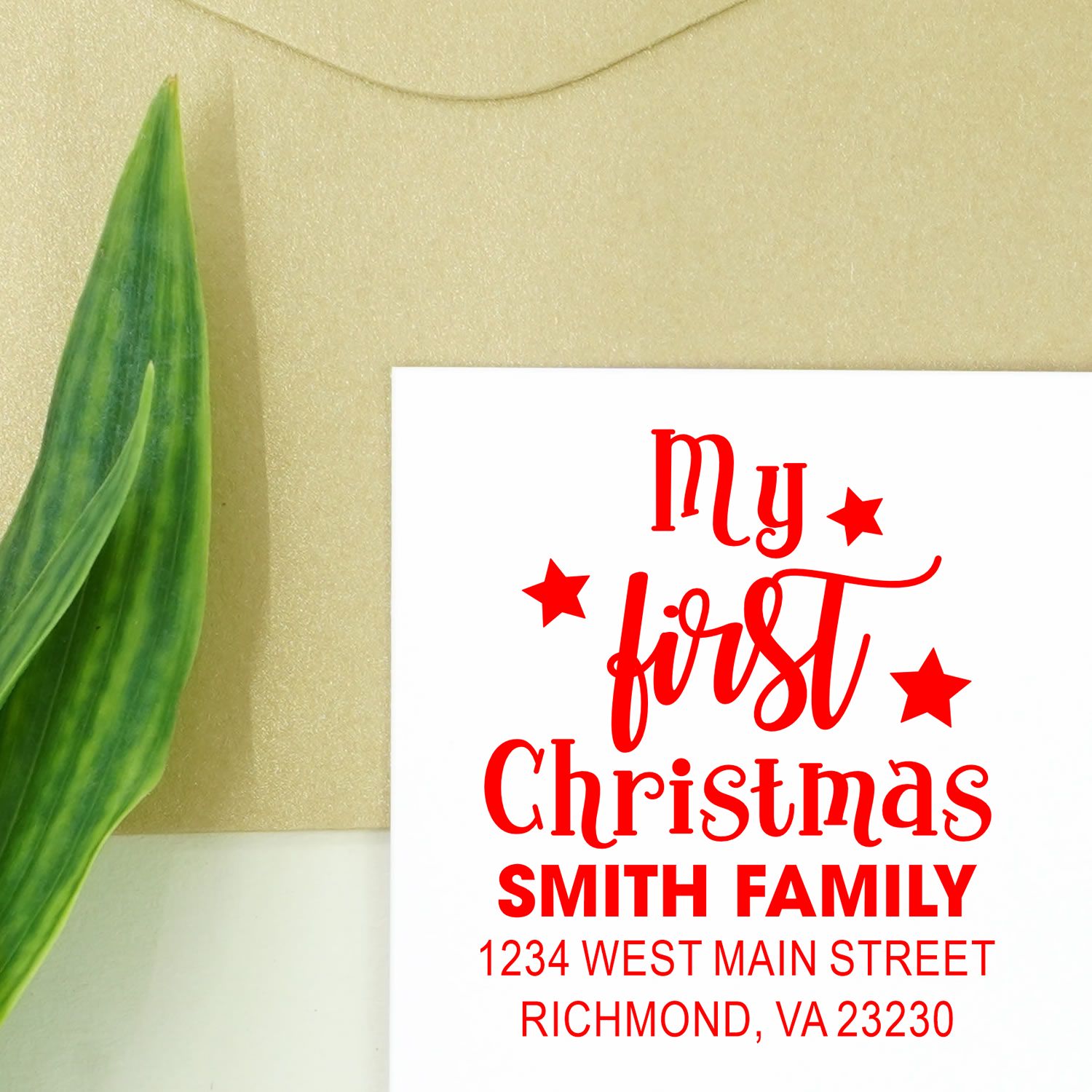 Custom My First Christmas rubber stamp with family name, return address, and festive stars for holiday cards.