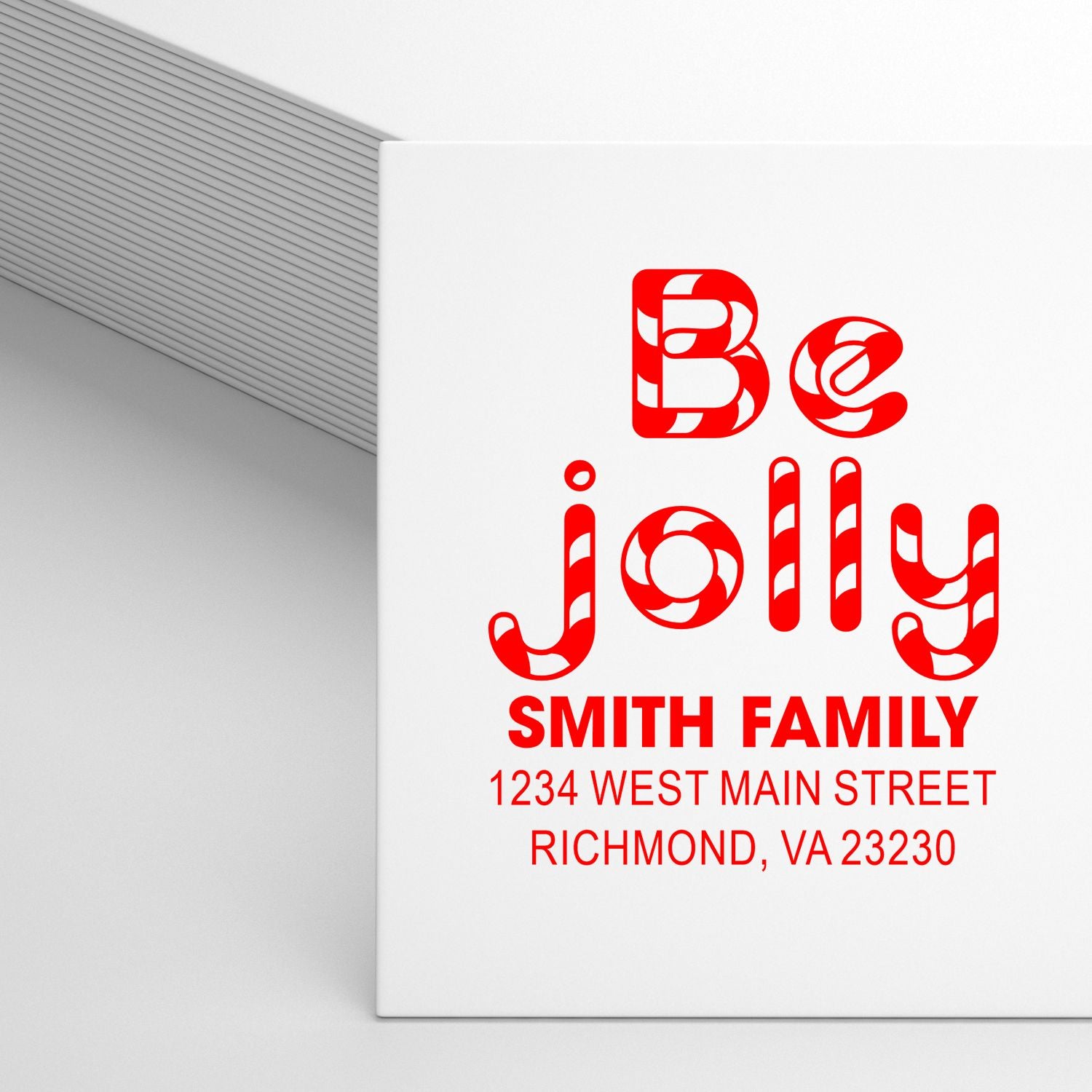 Custom holiday rubber stamp with Be Jolly design, Smith Family name, and return address for festive Christmas card envelopes.