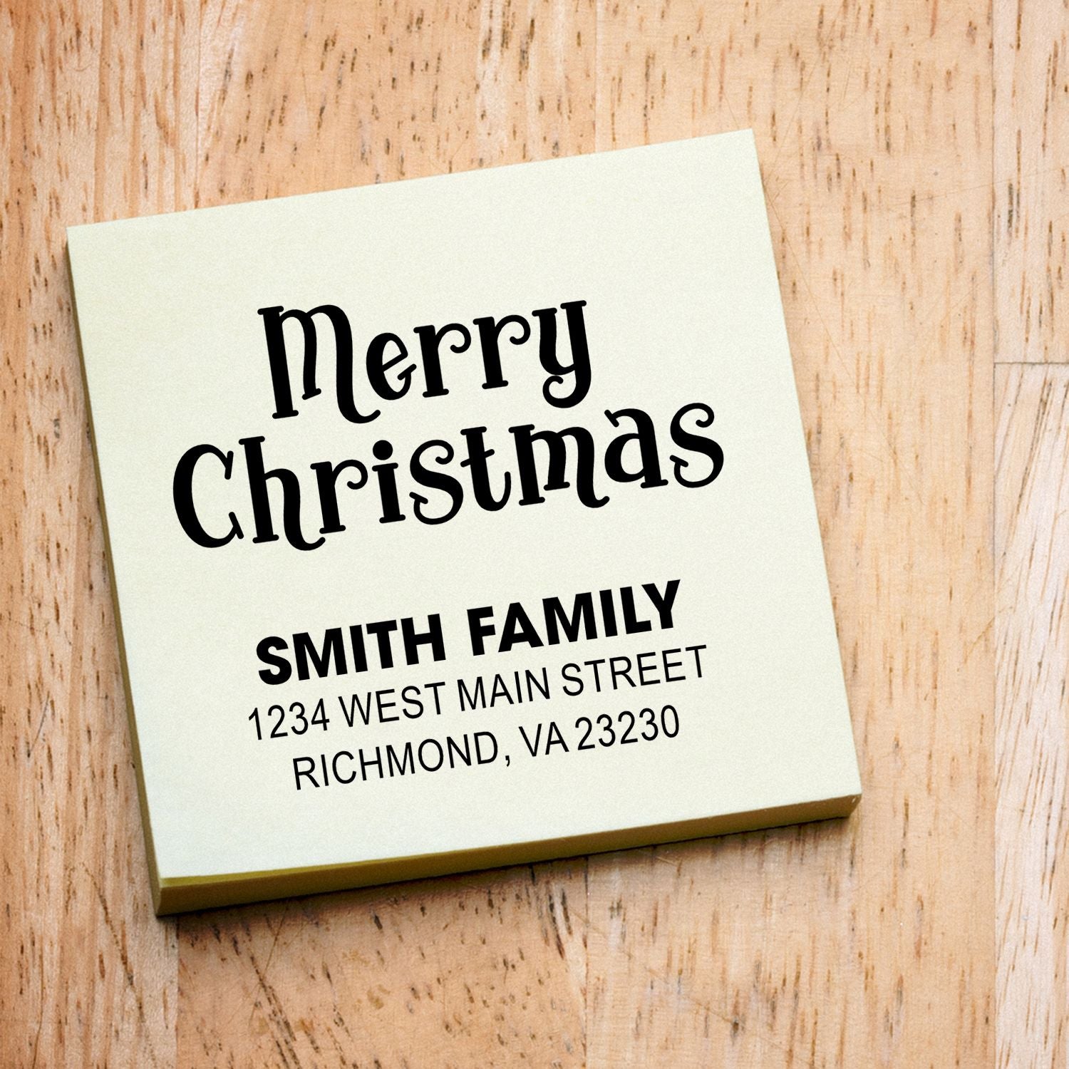 Custom Merry Christmas rubber stamp with Smith family name and address for holiday card envelopes.