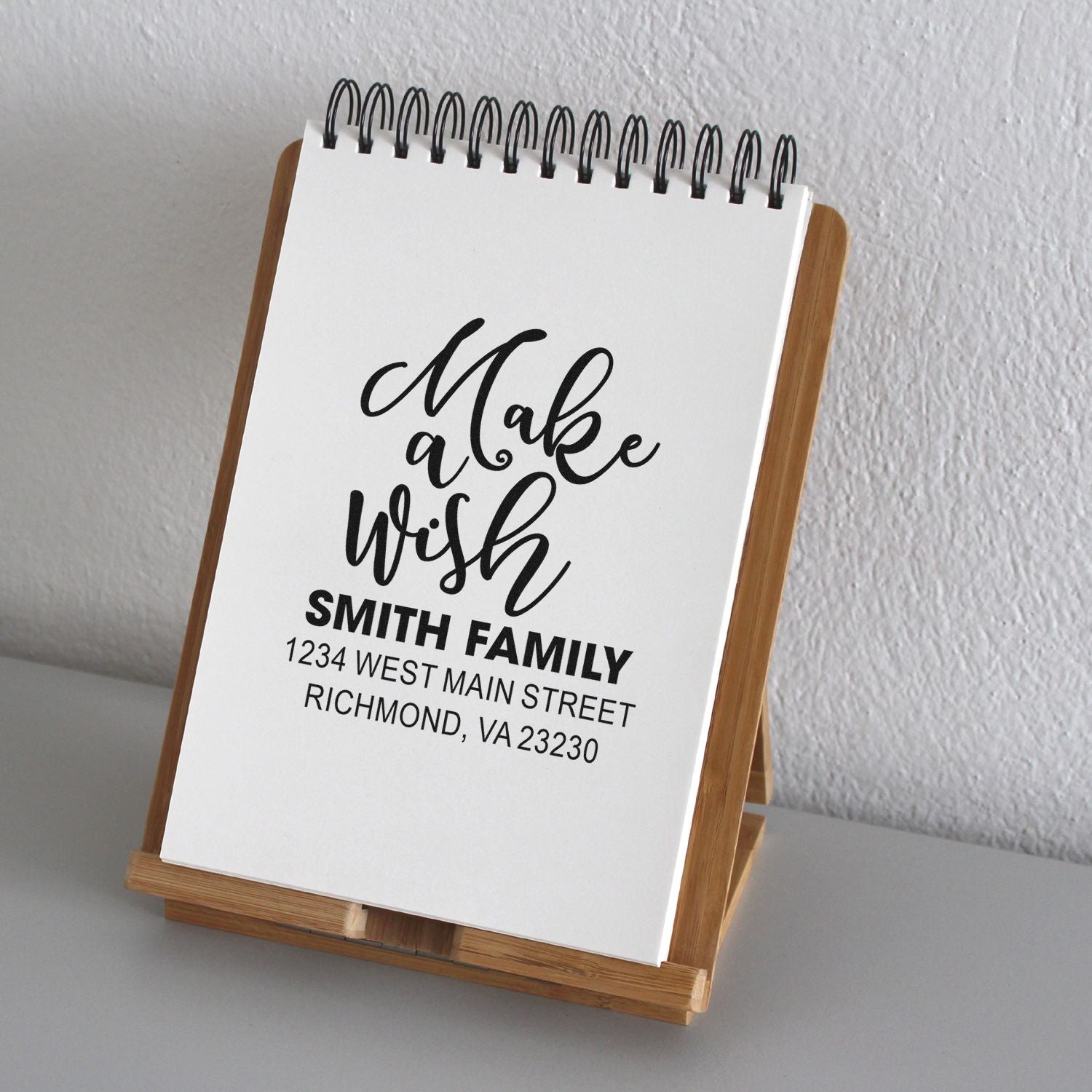 Personalized rubber address stamp with Make a wish script, Smith Family name, and return address for invitations or gifts.