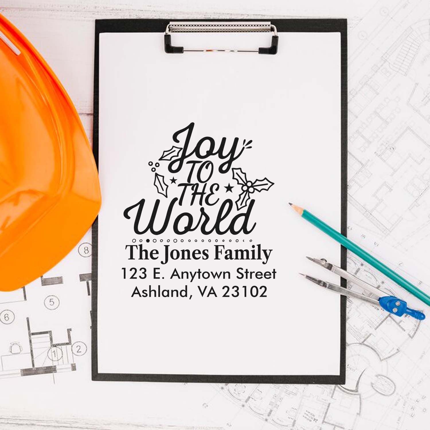 Custom Christmas address rubber stamp design featuring Joy to the World, family name, and mailing address.