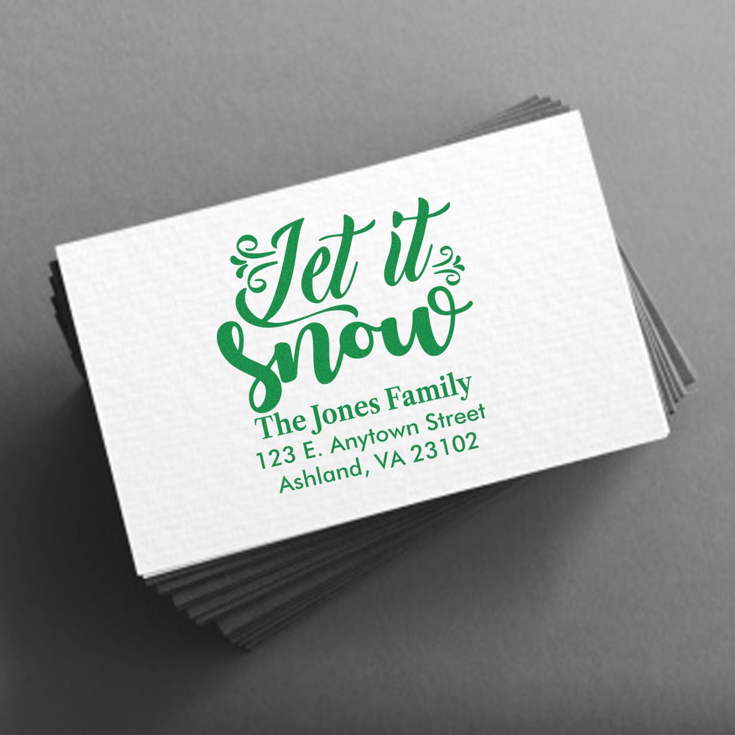 Personalized holiday rubber stamp with Let It Snow and family address for festive cards and envelopes.