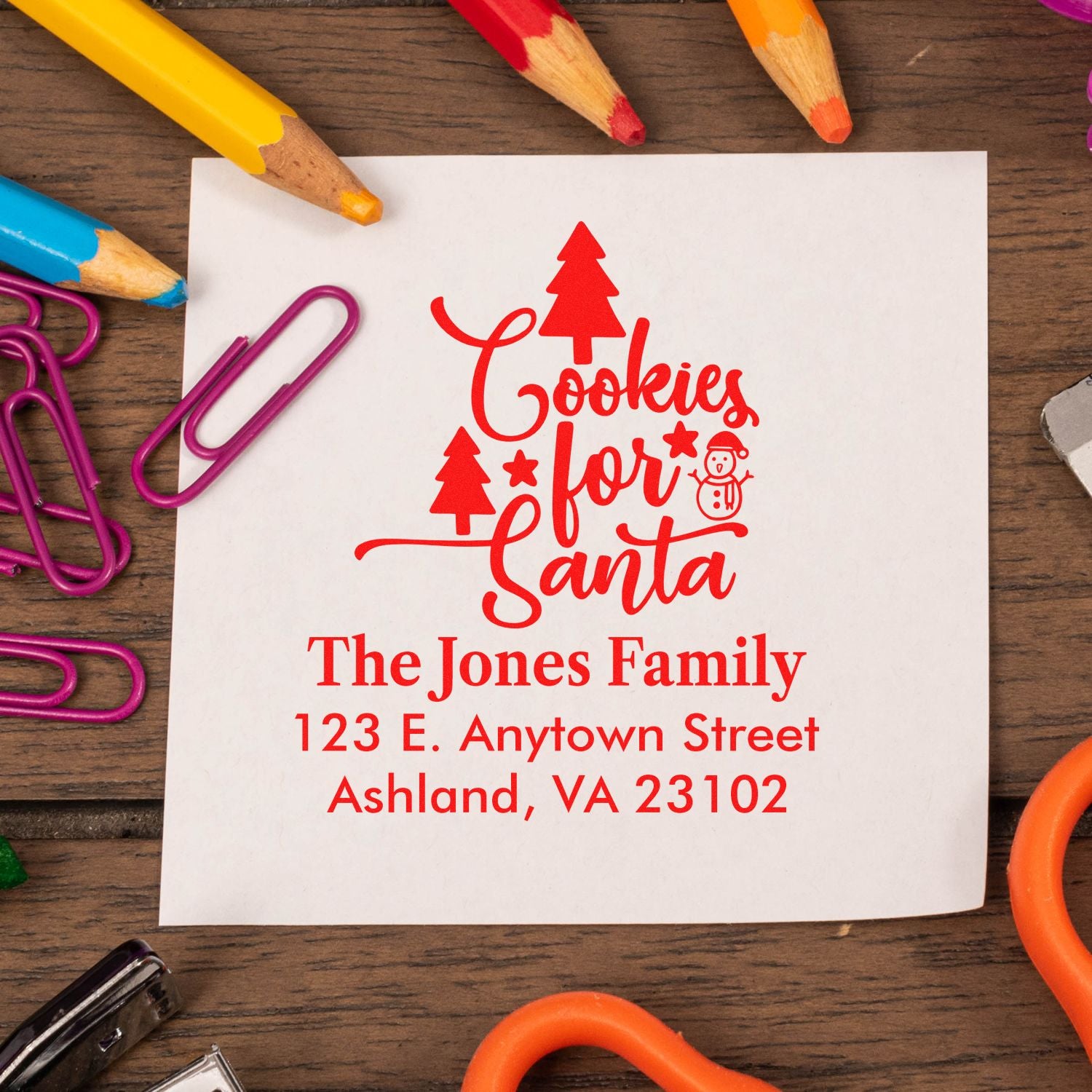 Custom Christmas rubber stamp with Cookies for Santa, family name, and return address for holiday cards and mailings.