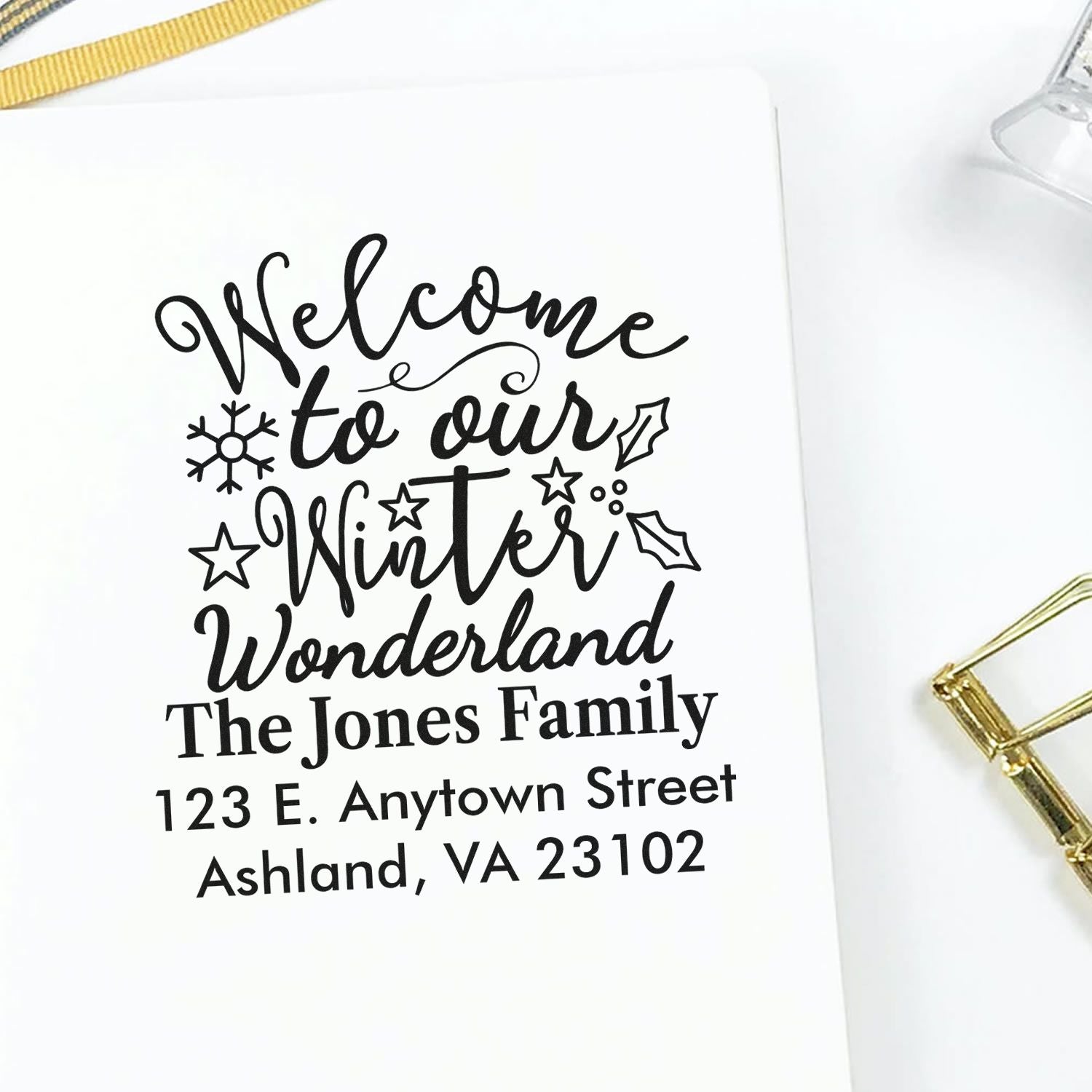 Personalized holiday address rubber stamp with Winter Wonderland greeting, family name, and return address.