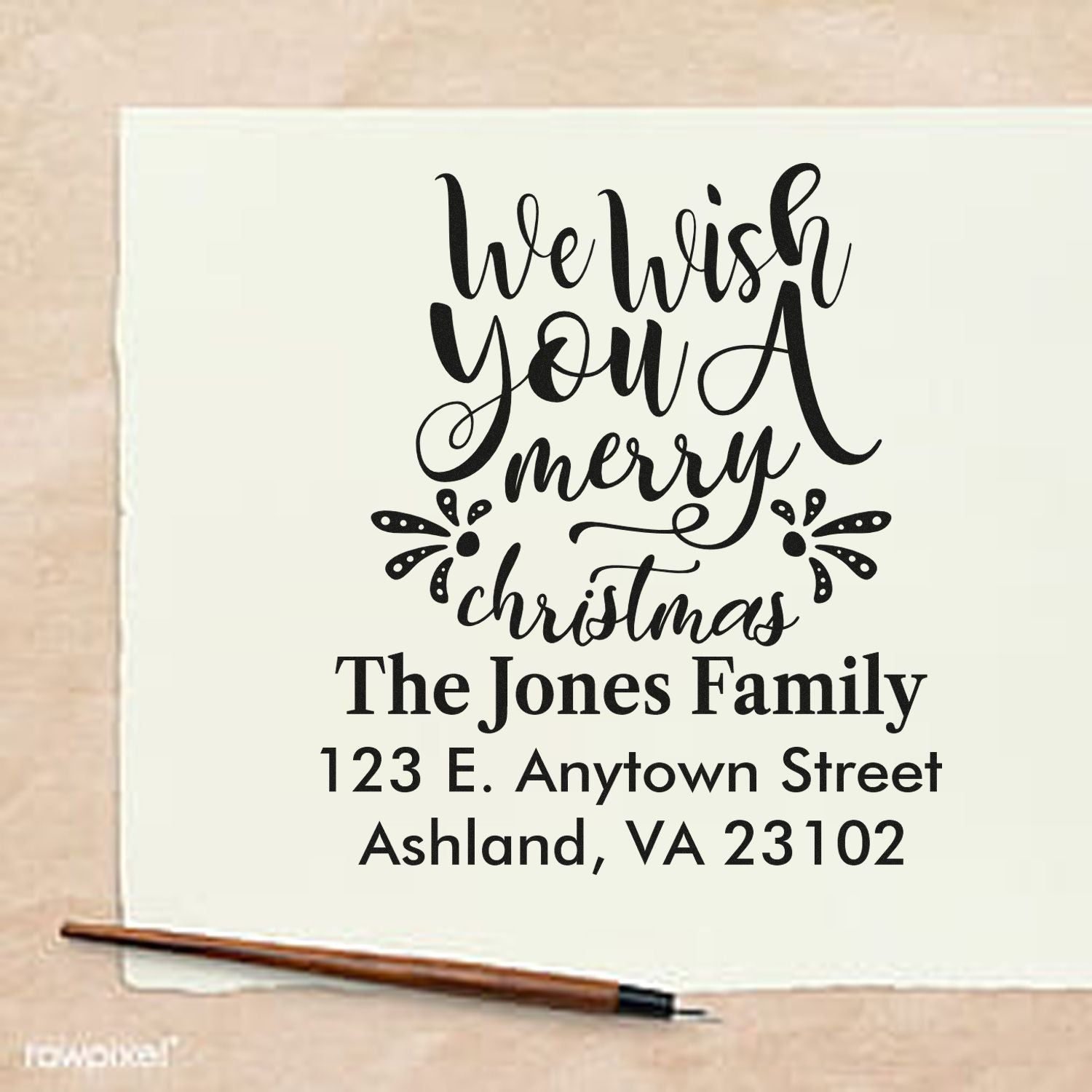 Personalized Christmas rubber stamp with return address for The Jones Family, featuring We Wish You a Merry Christmas design.