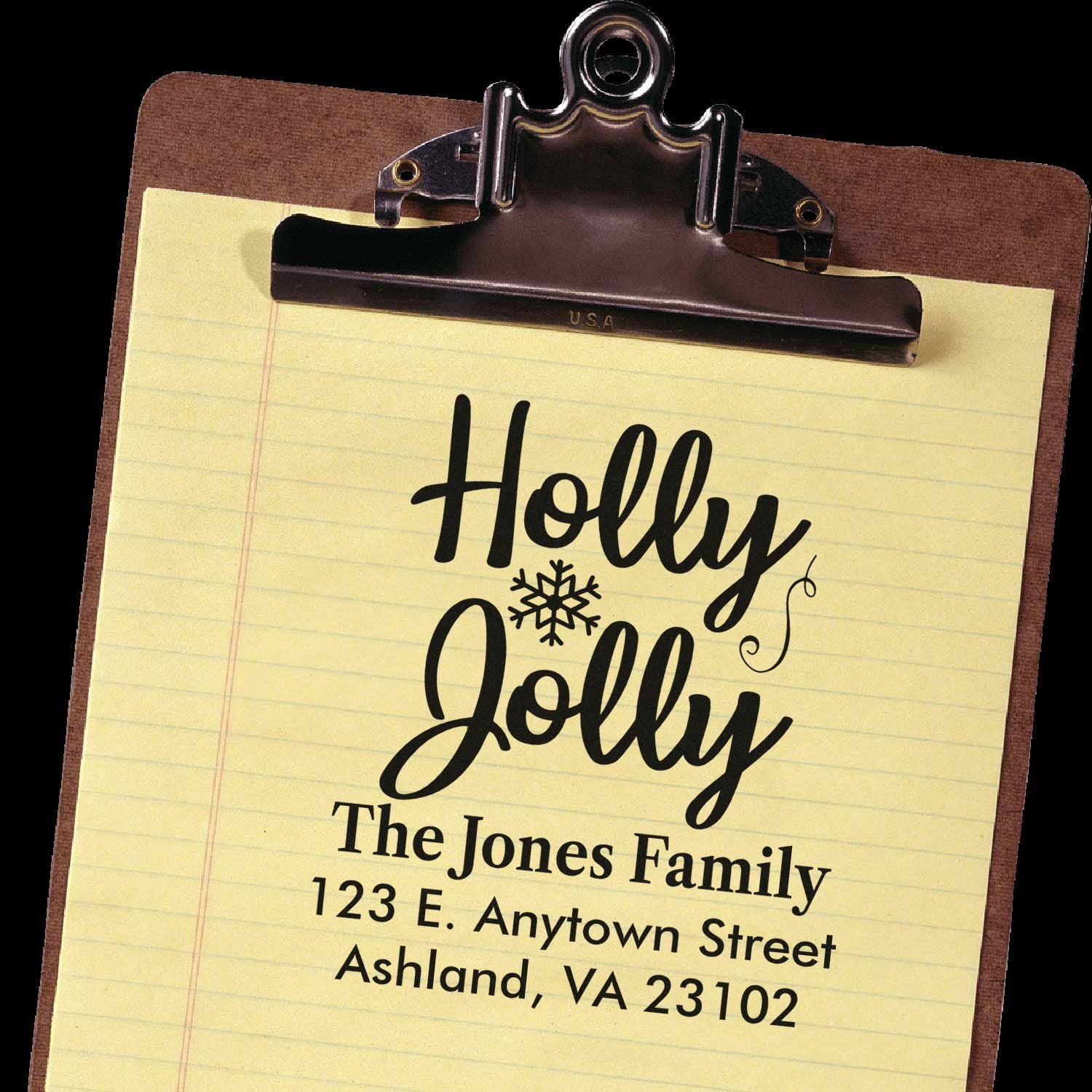 Custom Holly Jolly holiday address rubber stamp with personalized family name and mailing address on clipboard.