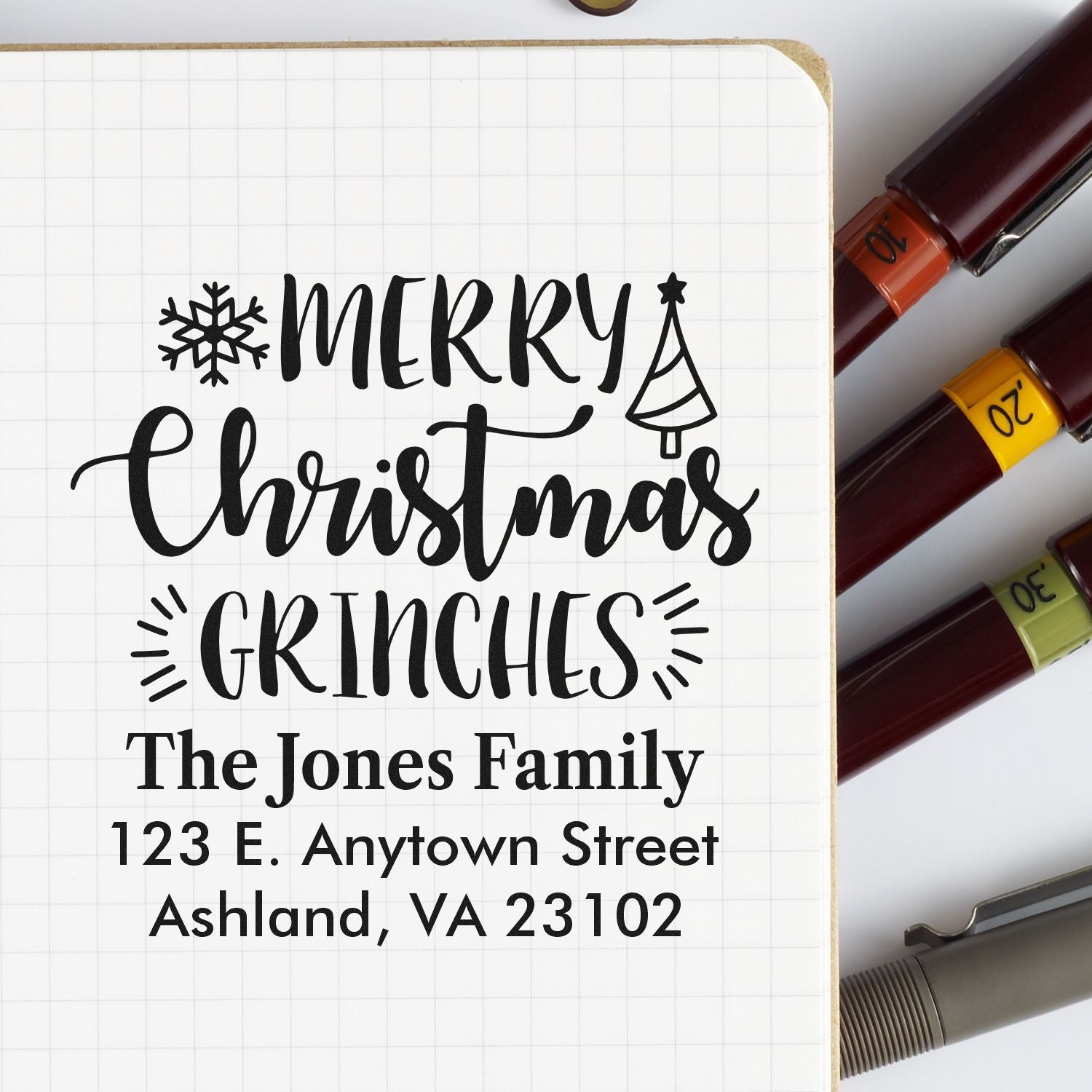 Custom Christmas rubber stamp design with Merry Christmas Grinches and personalized family address.