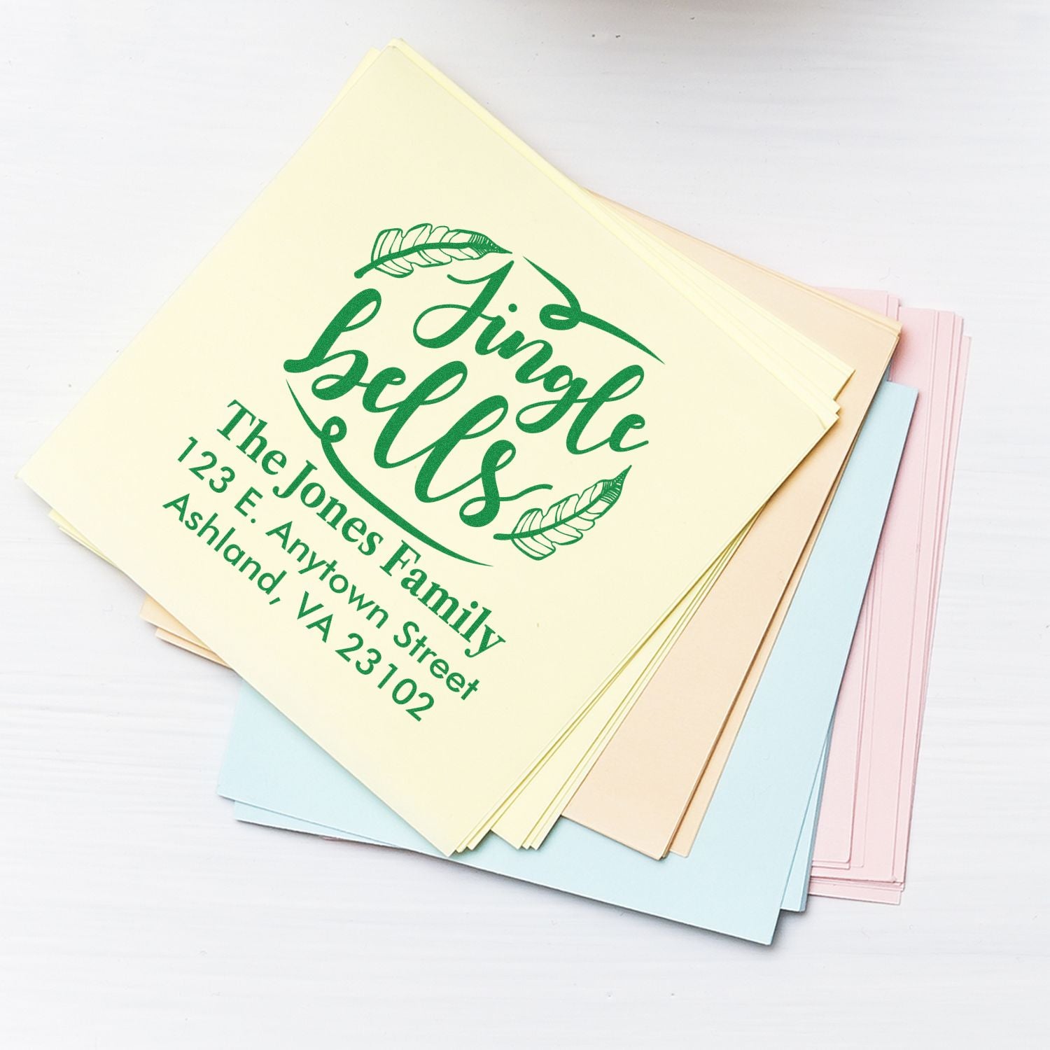 Personalized return address rubber stamp for The Jones Family on pastel envelopes and stationery