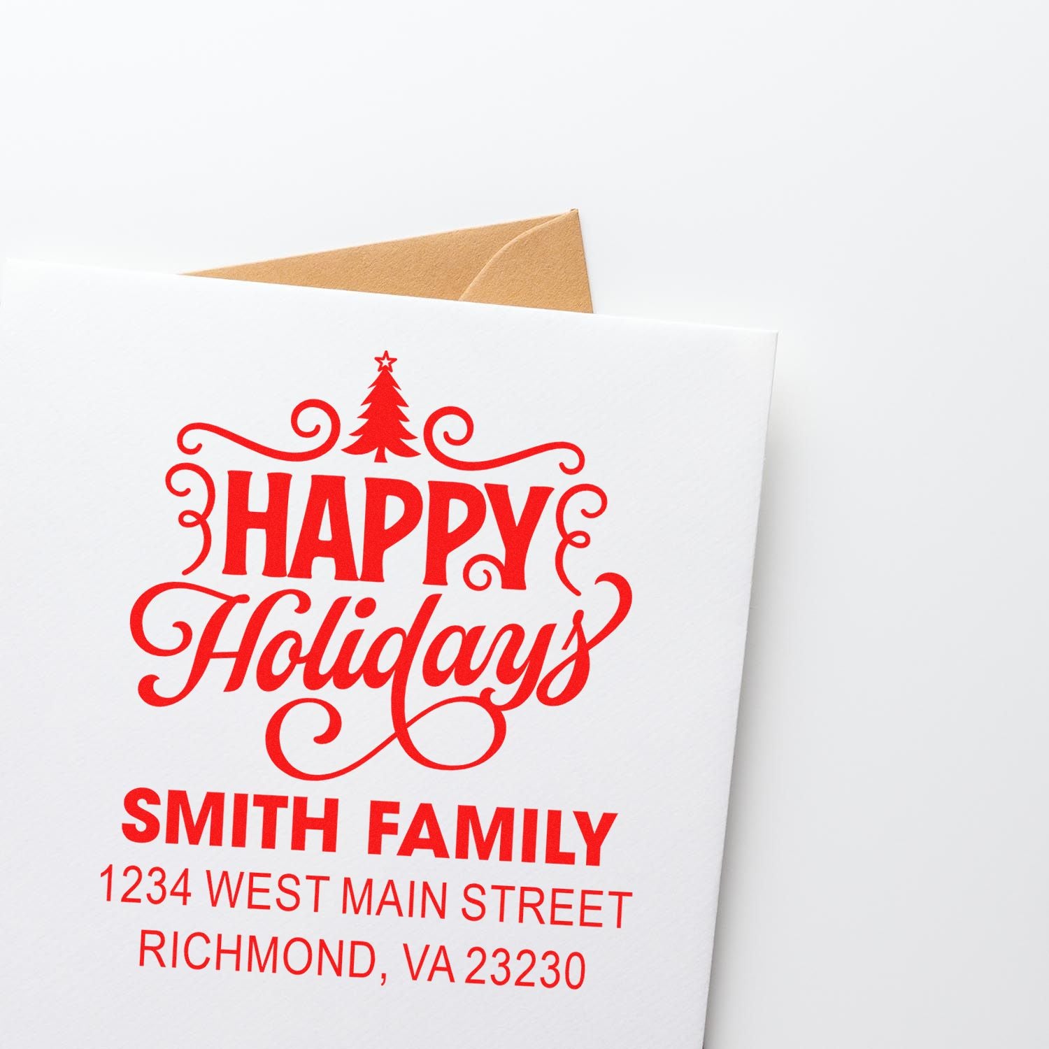 Custom holiday rubber stamp with Happy Holidays and Smith family address on a greeting card envelope.