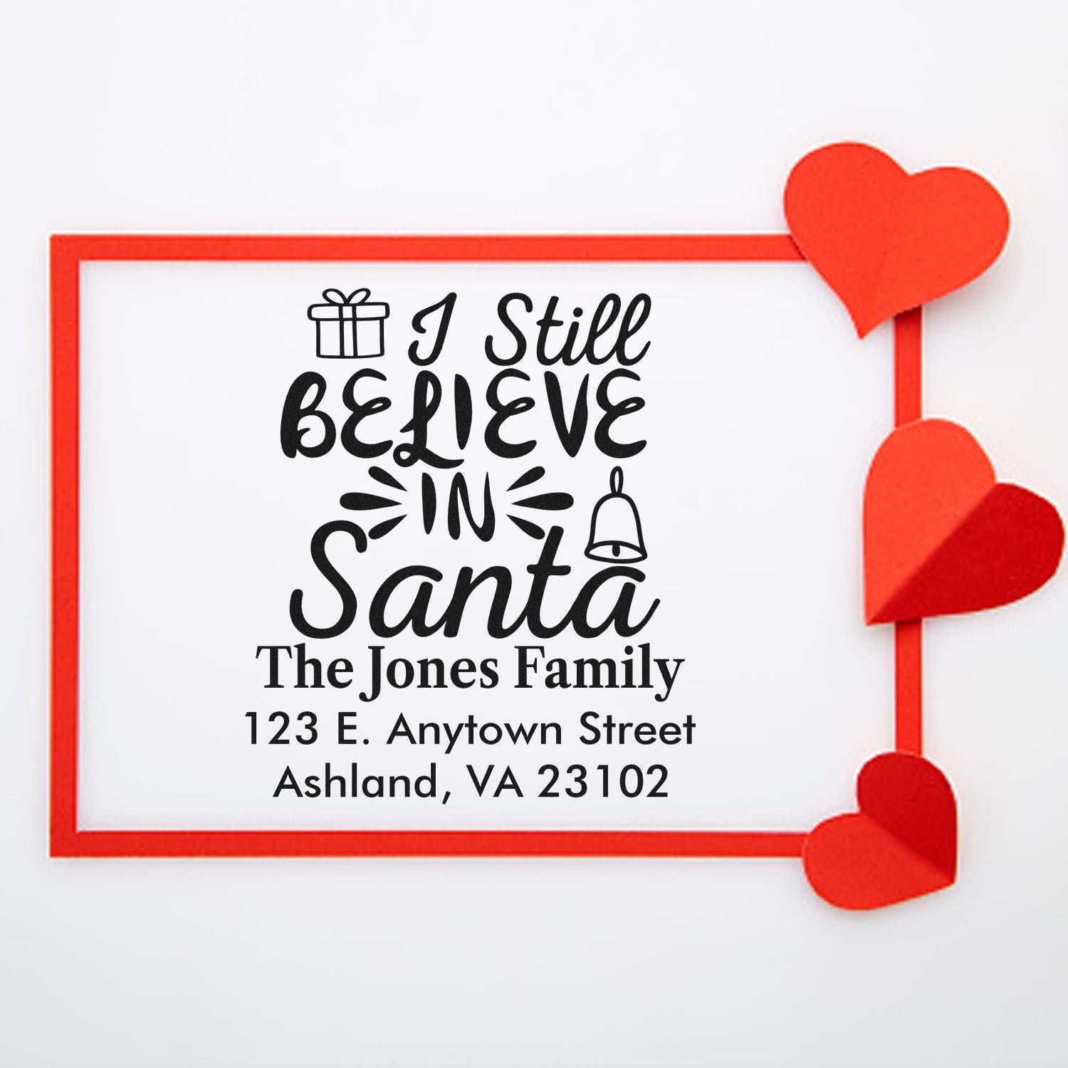 Custom Christmas return address rubber stamp with I Still Believe in Santa and personalized family address.