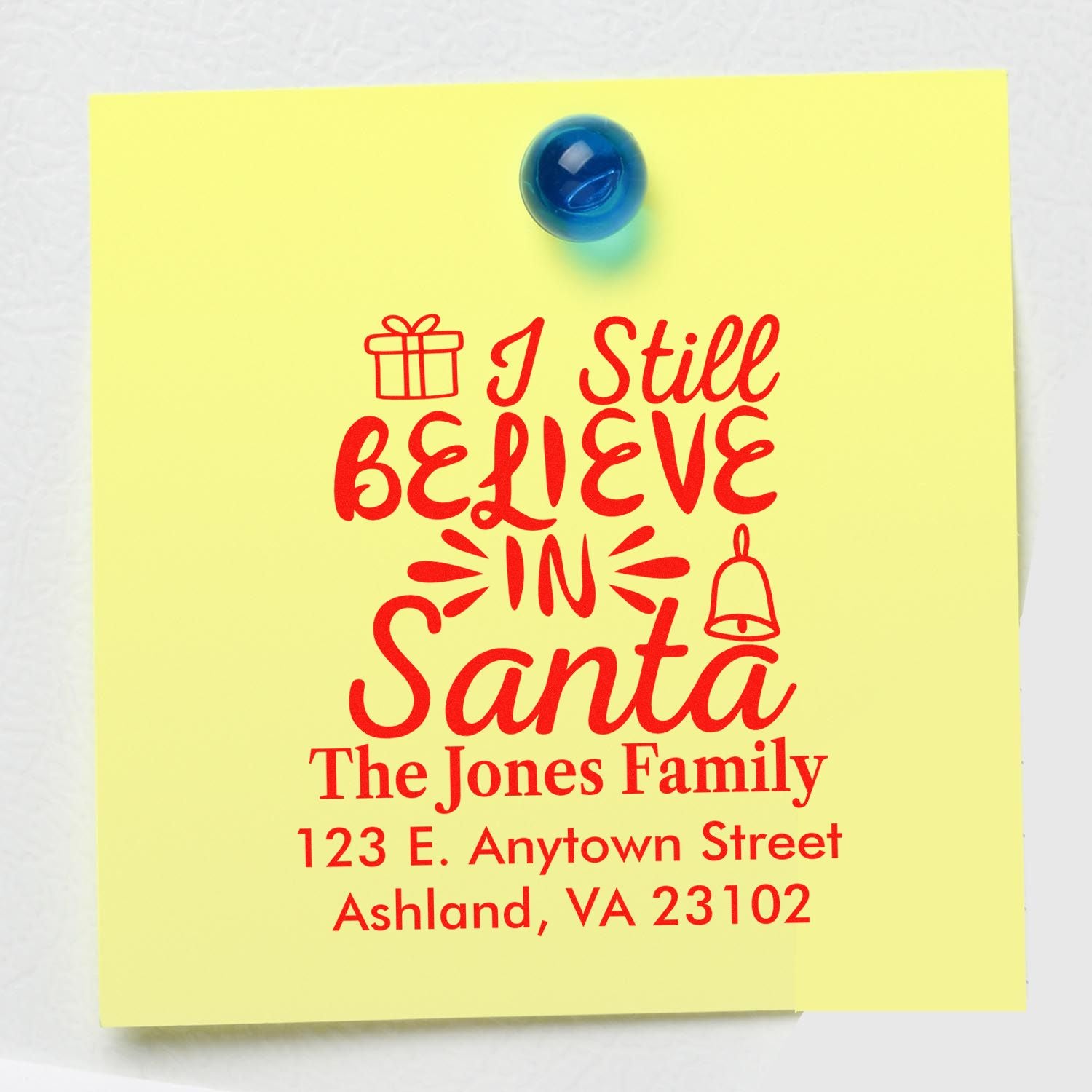 Custom Christmas rubber stamp with I Still Believe in Santa and family return address for holiday mail.