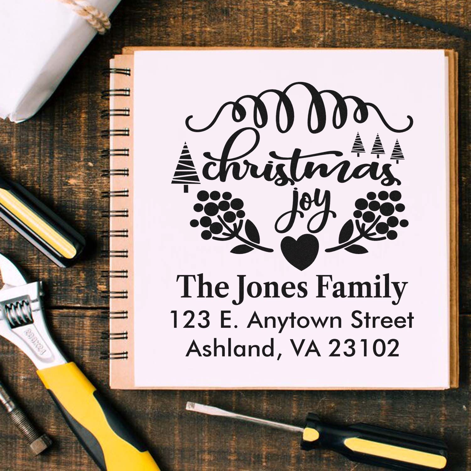 Personalized Christmas return address rubber stamp with family name, address, and holiday wreath design.