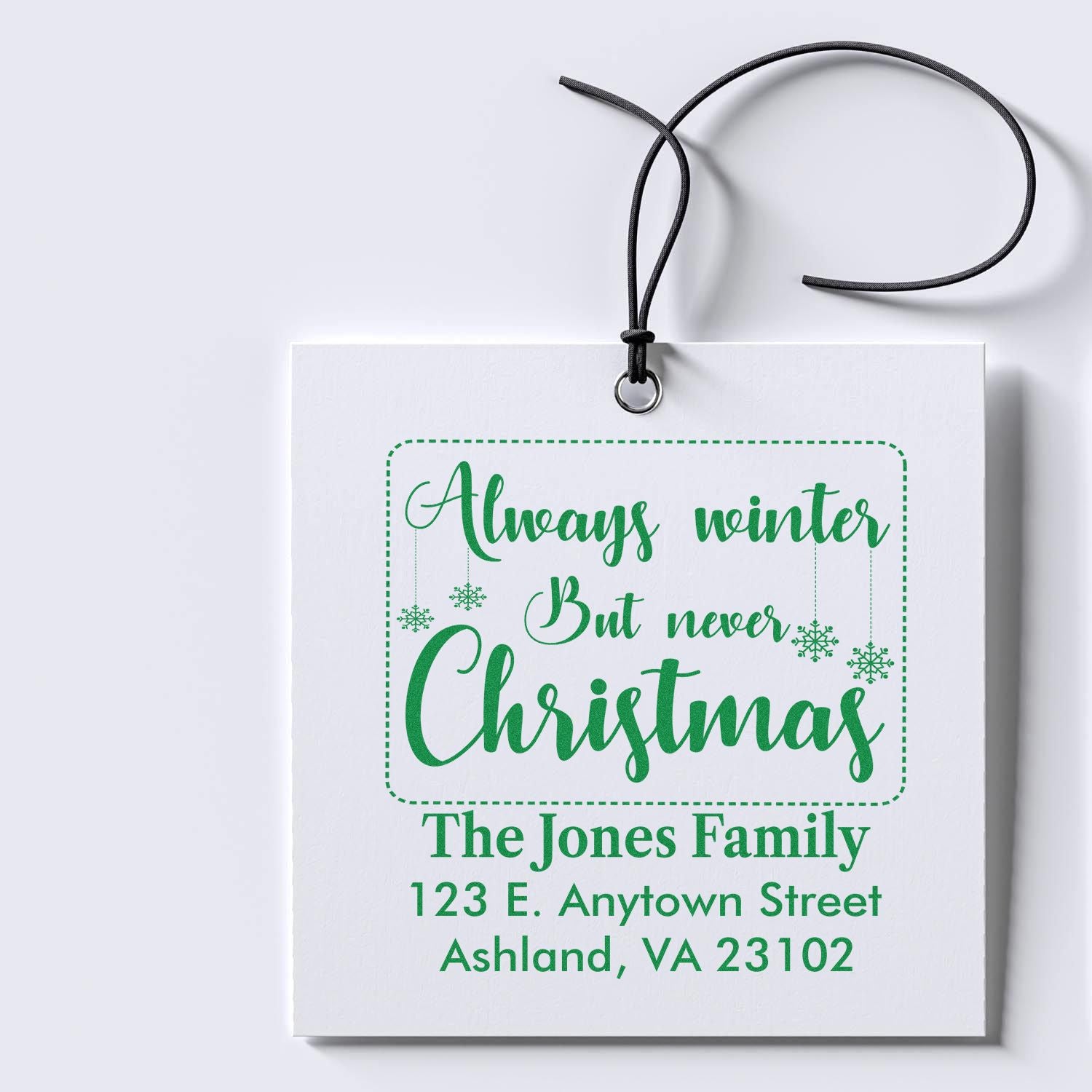 Custom Christmas rubber stamp return address design for The Jones Family with festive "Always winter but never Christmas" text.