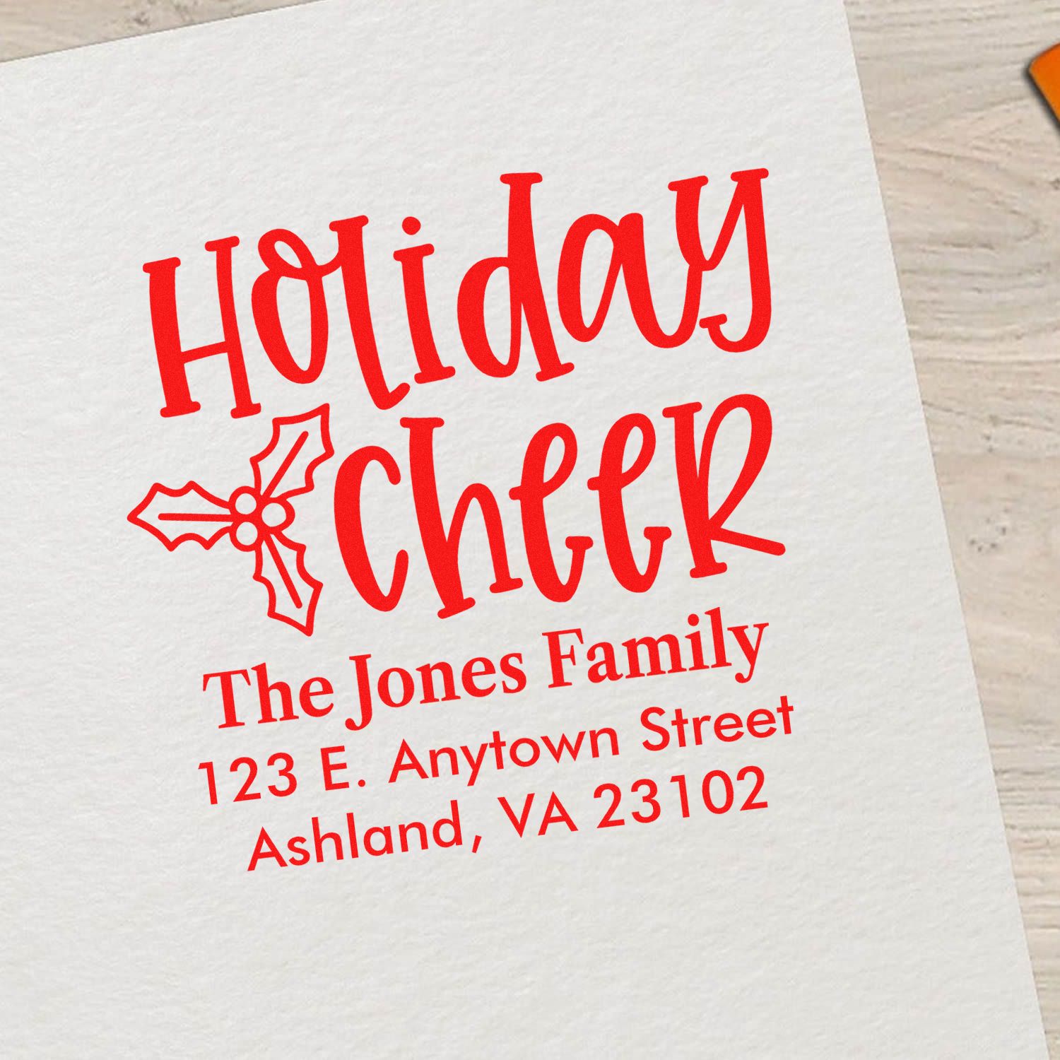 Custom holiday return address rubber stamp with family name for Christmas cards and festive envelopes.