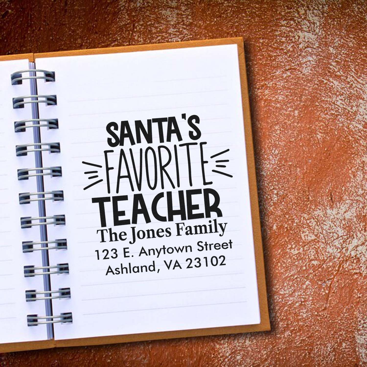 Custom rubber stamp for holiday teacher gifts with personalized Santa's Favorite Teacher return address design.