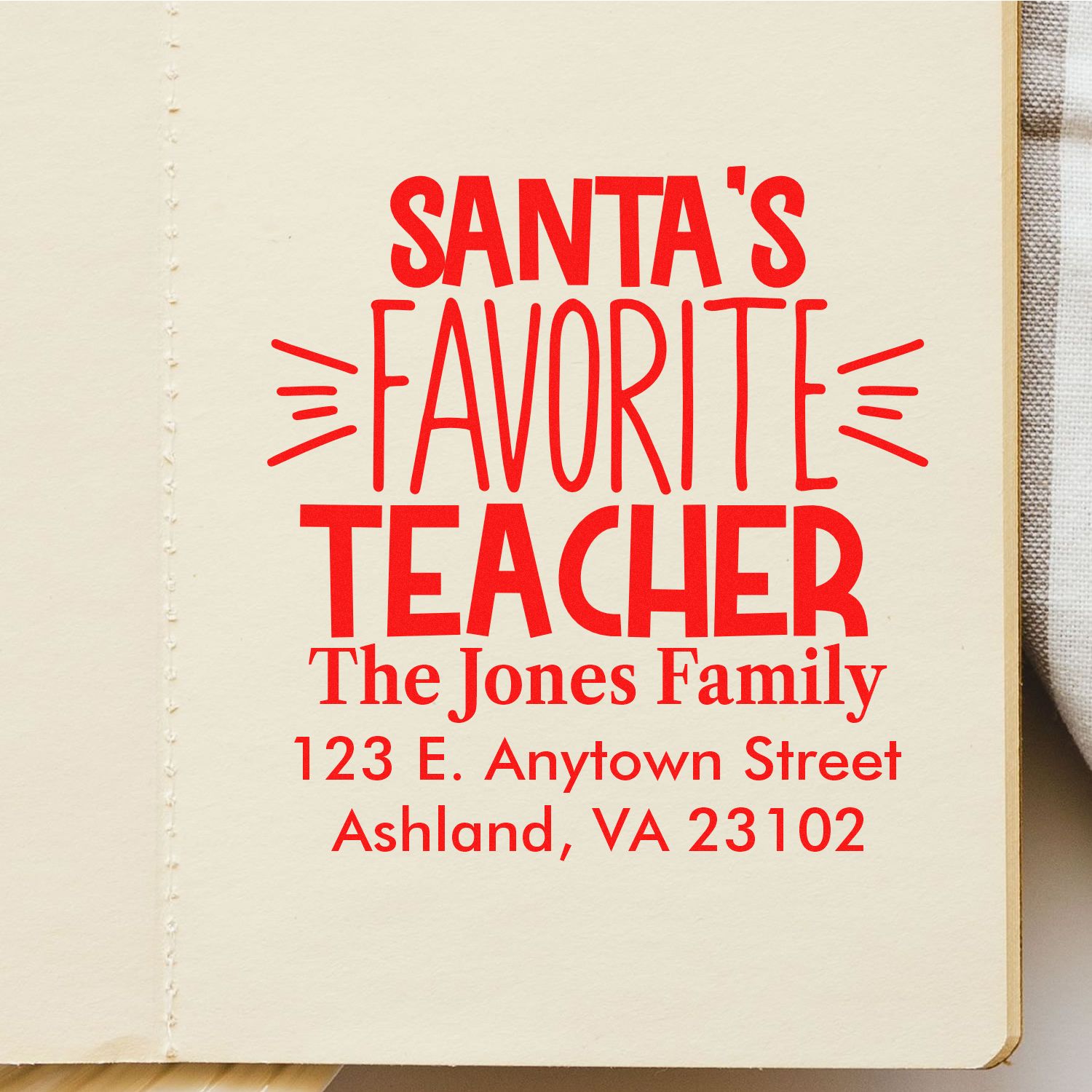 Custom Santas Favorite Teacher rubber stamp with family name and address for Christmas teacher gifts.