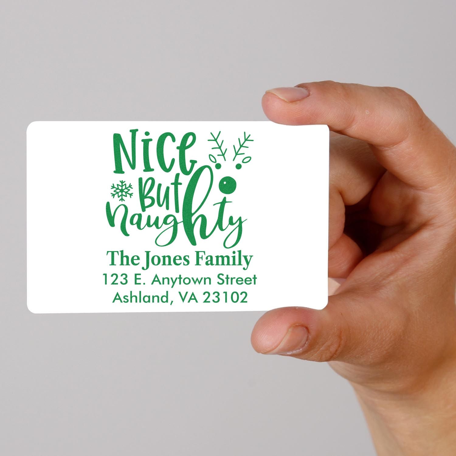 Custom holiday rubber stamp with Nice But Naughty design and The Jones Family return address.