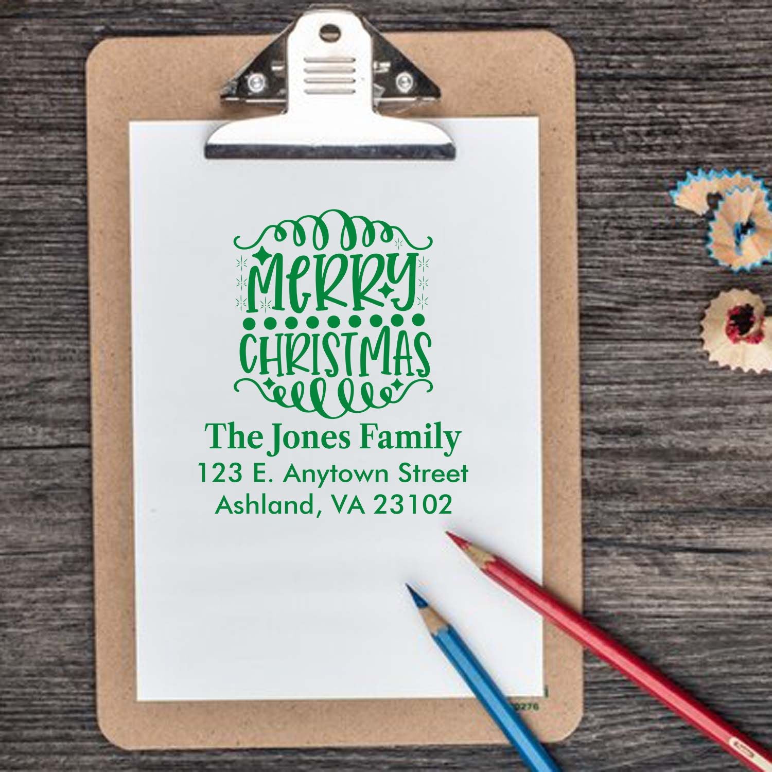 Custom Merry Christmas rubber stamp with family name and address for holiday cards and festive stationery.