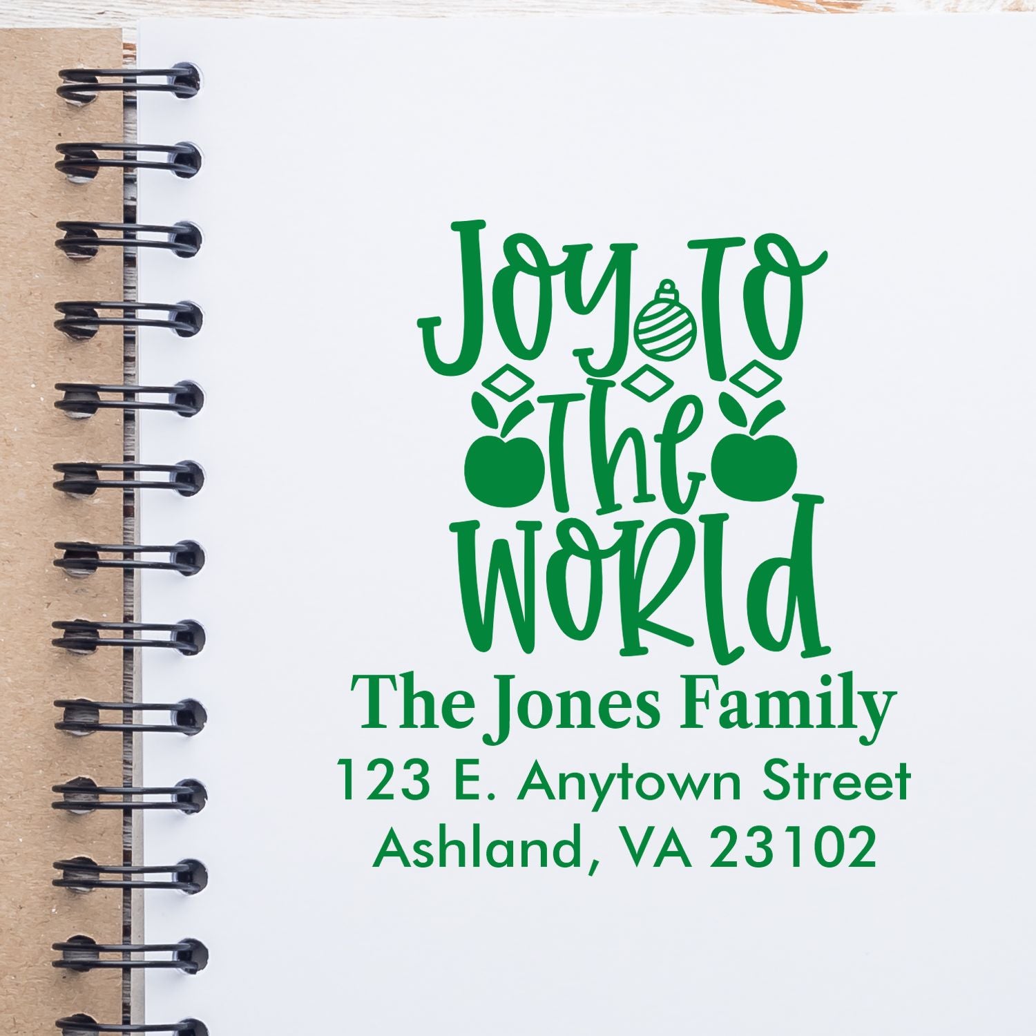 Custom Christmas rubber stamp design with Joy to the World and personalized family return address for holiday cards.