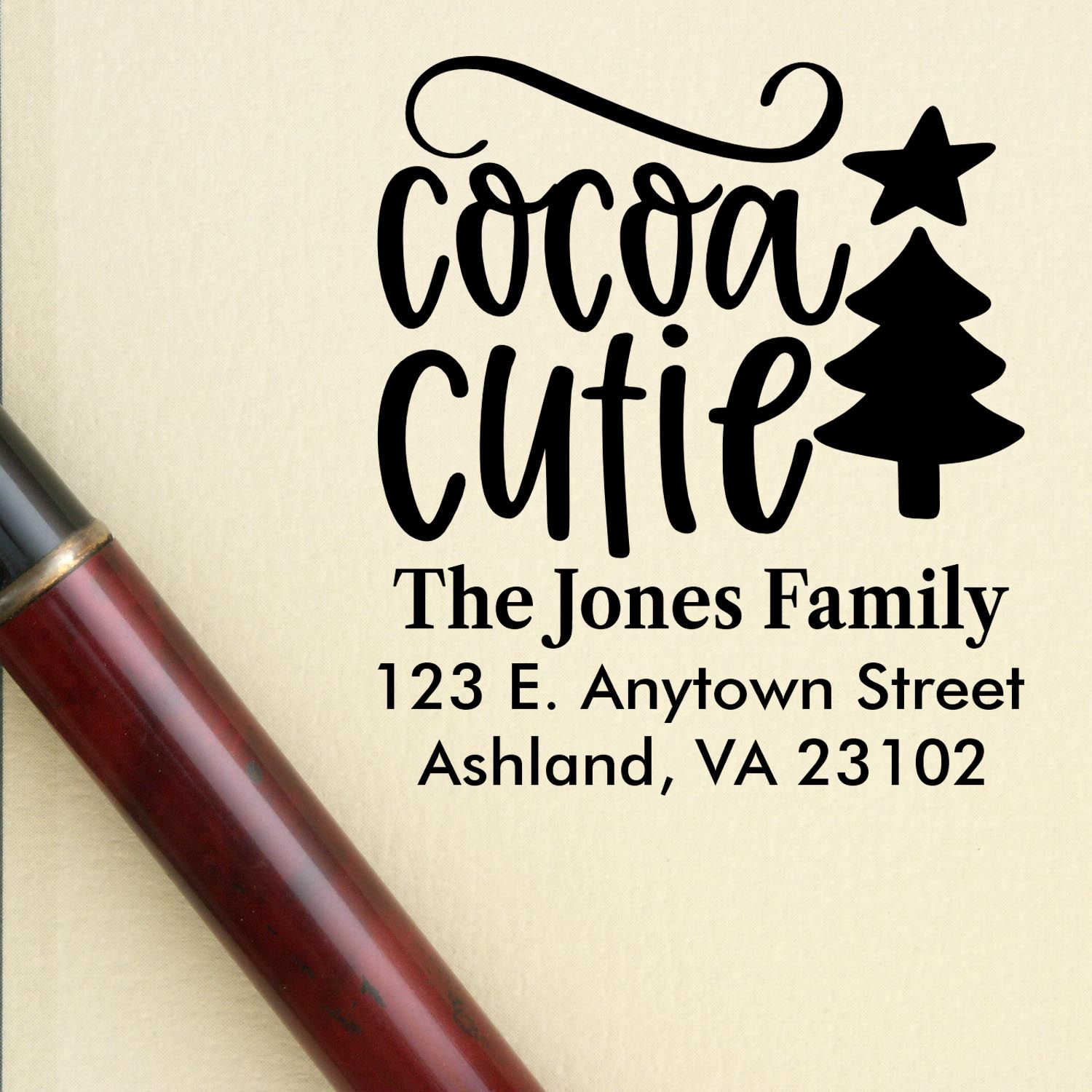 Custom rubber stamp with Cocoa Cutie holiday design, personalized family address, and Christmas tree for festive mailings.
