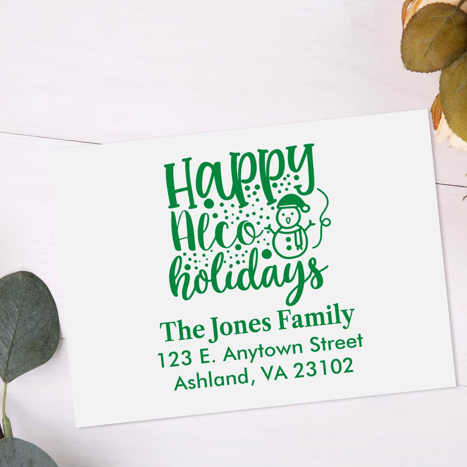 Custom holiday return address rubber stamp with snowman design and family name for festive Christmas card envelopes.
