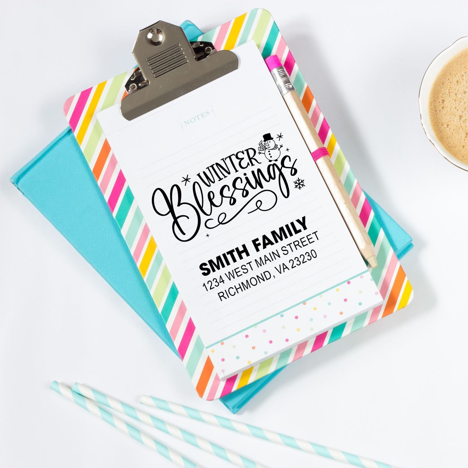 Personalized winter blessings rubber stamp on notepad with Smith family return address stamp and colorful stationery.