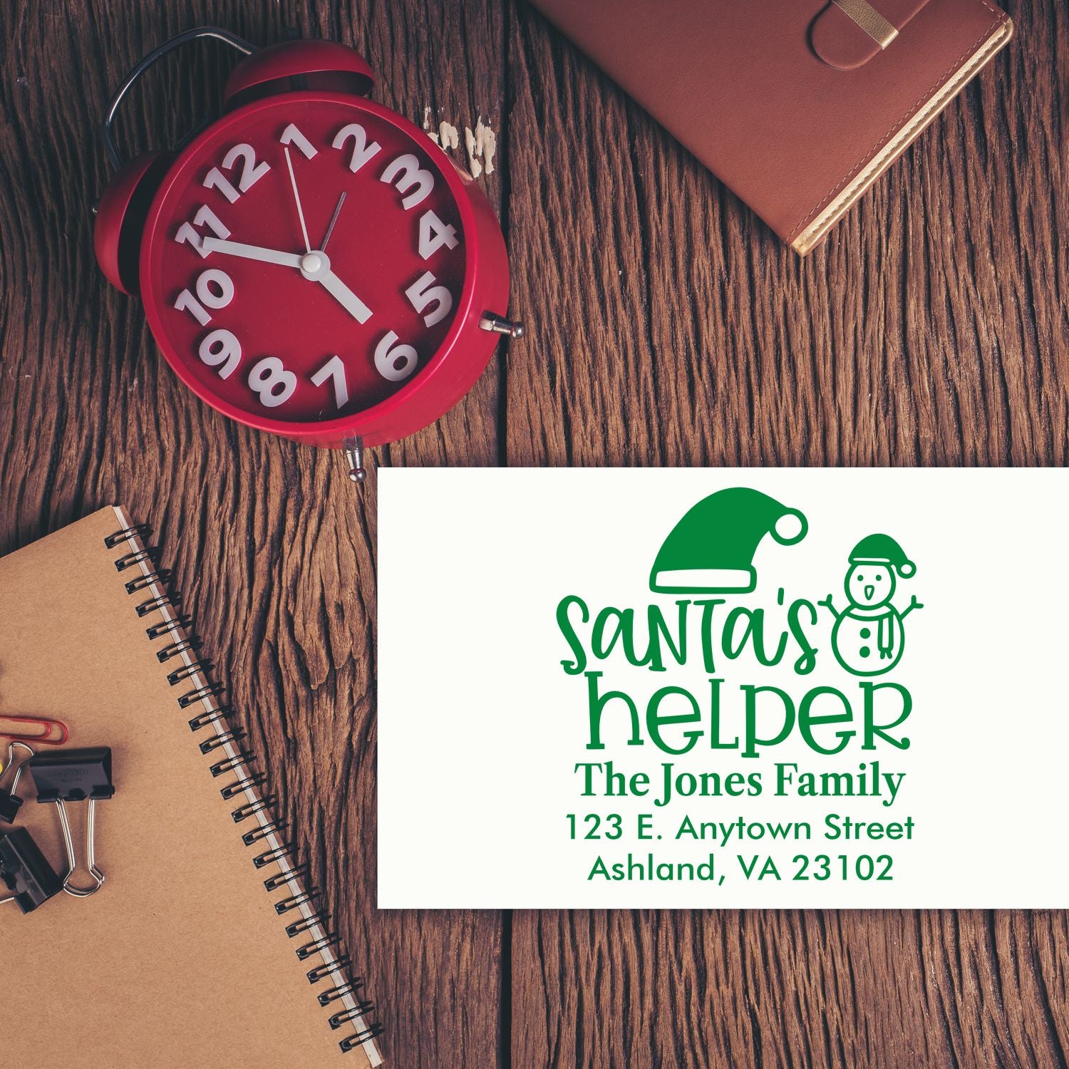 Custom Christmas address stamp with Santas helper design, family name, and return address for holiday cards and envelopes.