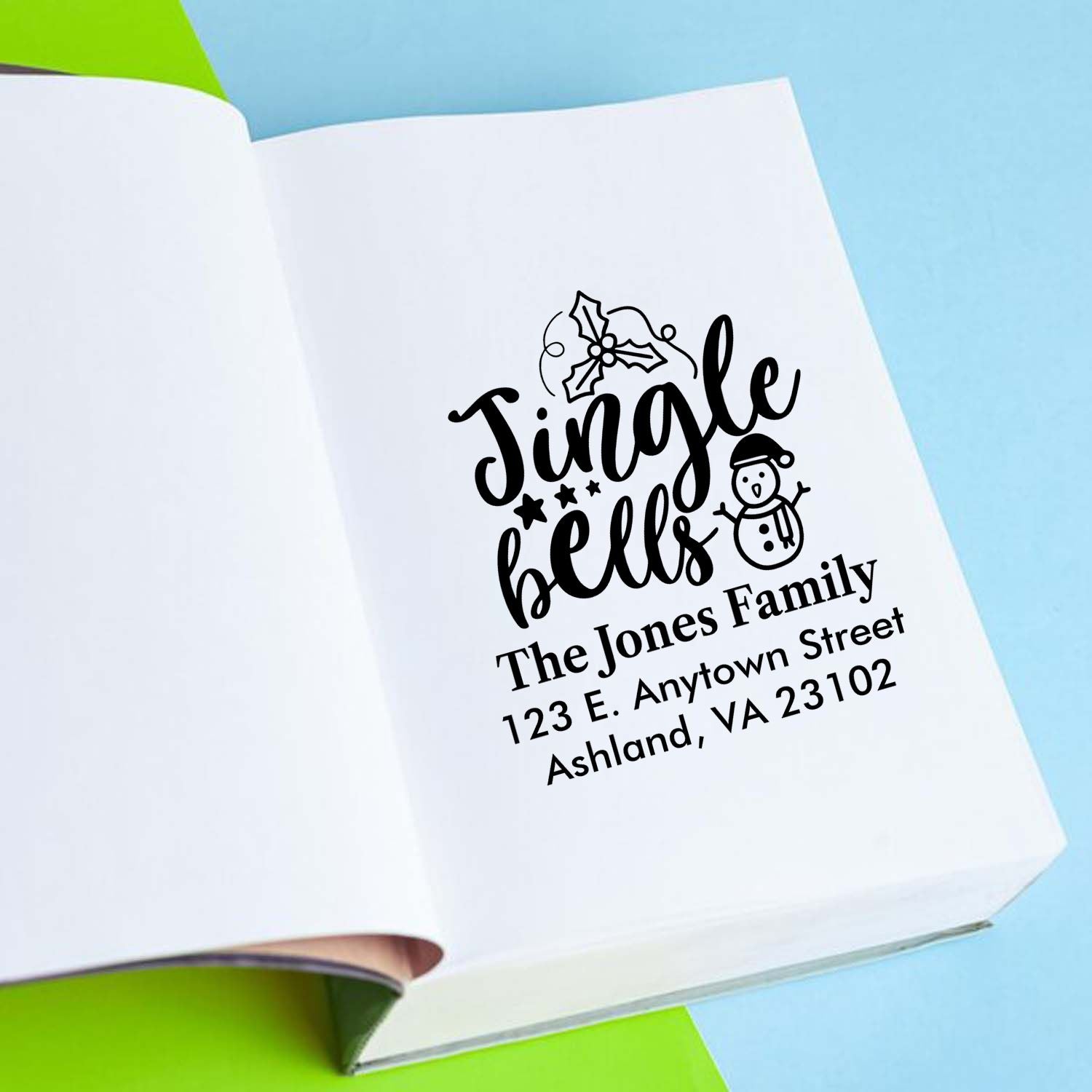 Personalized Christmas rubber stamp with Jingle Bells design and family return address for holiday mail.