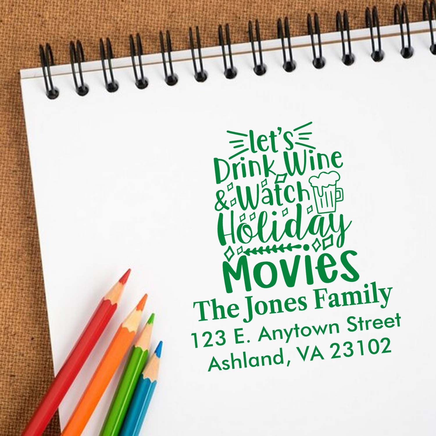 Custom holiday rubber stamp with wine and movie quote, personalized with family name and address for festive cards and crafts.