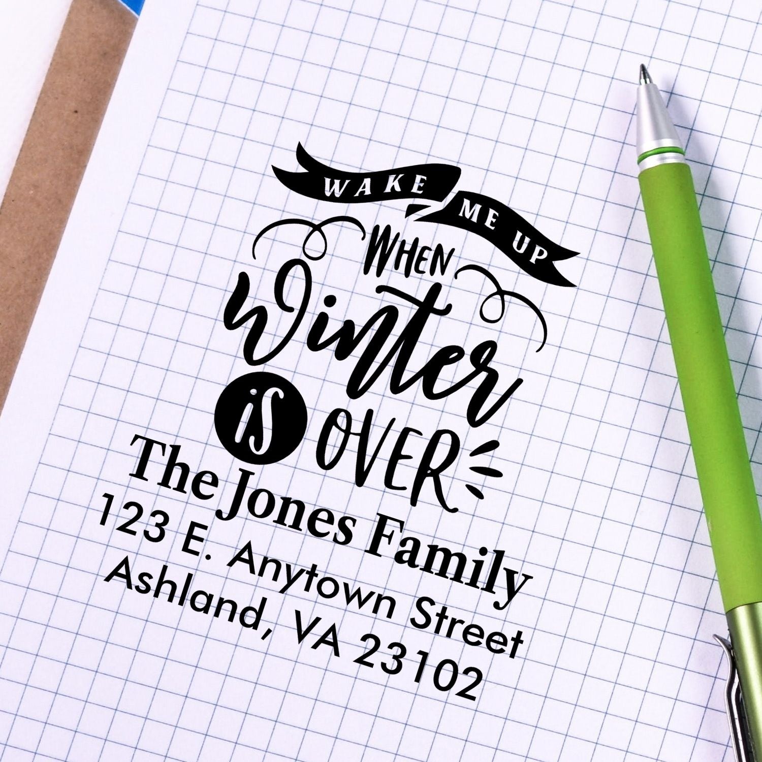 Custom rubber address stamp with Wake Me Up When Winter Is Over design and Jones Family address on grid paper