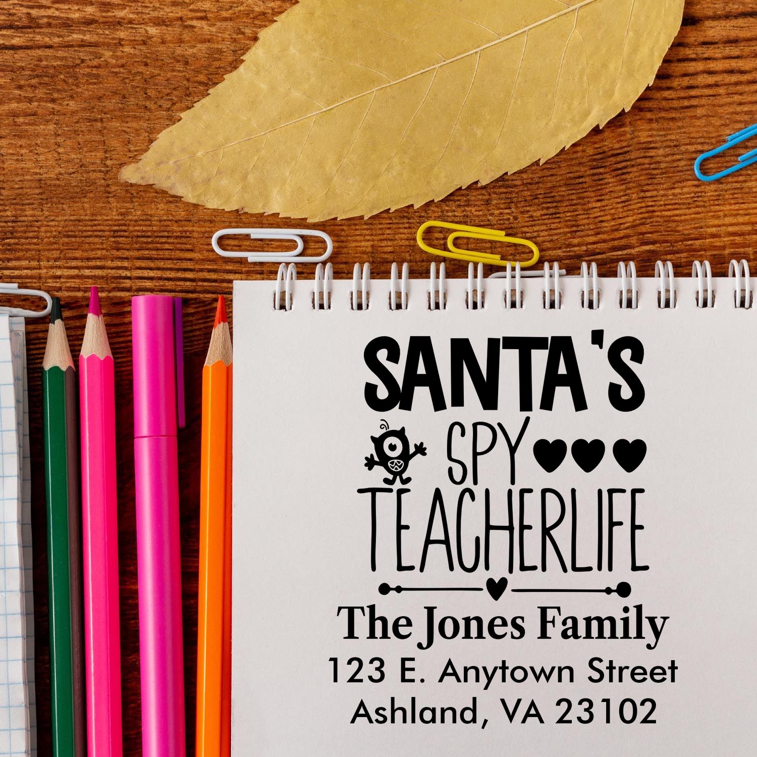 Personalized Christmas teacher address rubber stamp with Santas Spy Teacherlife design, family name, and mailing address.