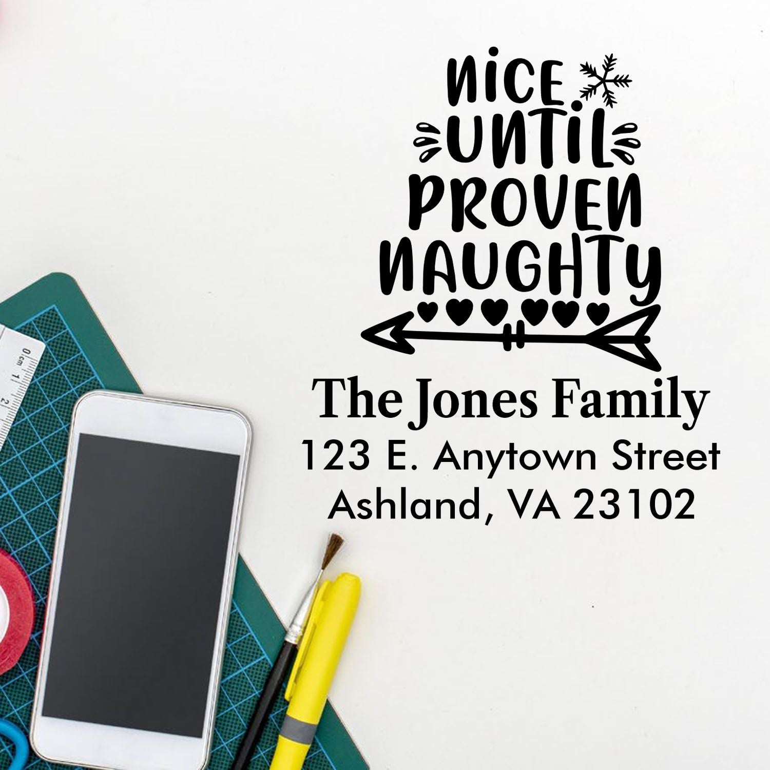 Custom rubber stamp design reading Nice Until Proven Naughty with family name and address for personalized holiday mail.