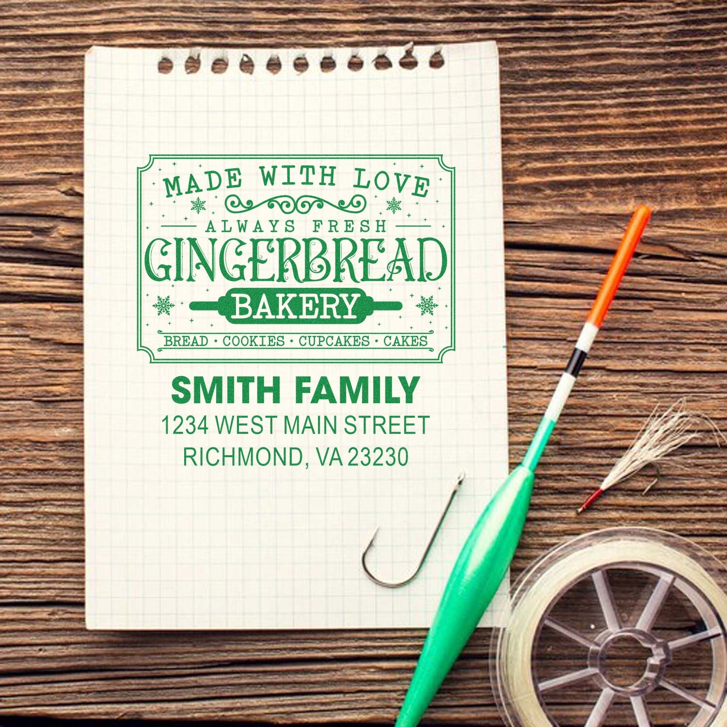 Personalized gingerbread bakery rubber stamp with family name and address for custom branding and packaging.