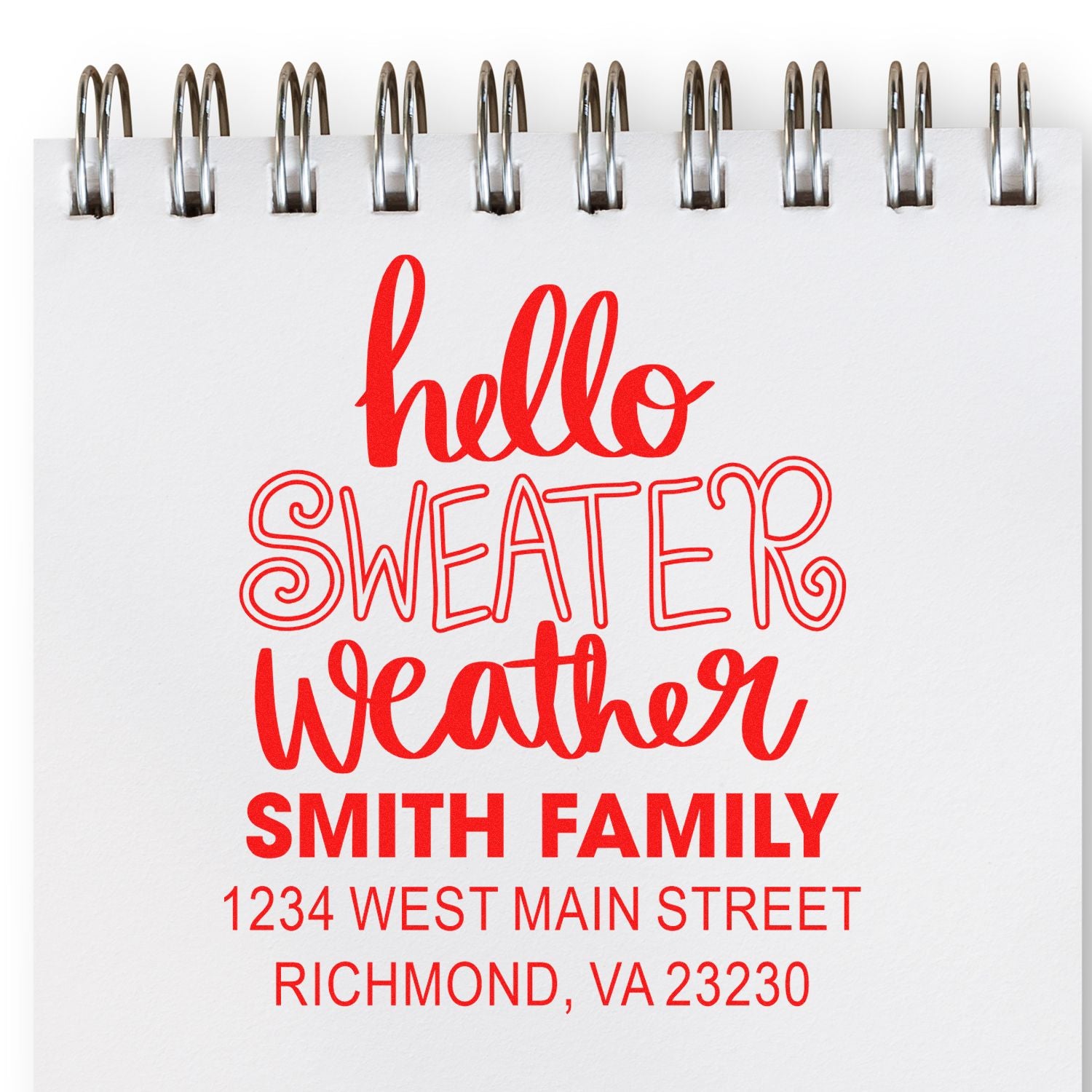 Custom address rubber stamp with hello sweater weather for Smith Family, shown on a notepad.
