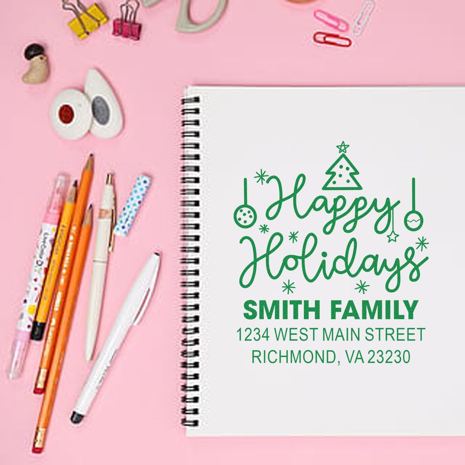 Custom Happy Holidays rubber stamp with Smith Family return address on notebook, perfect for festive holiday stationery.