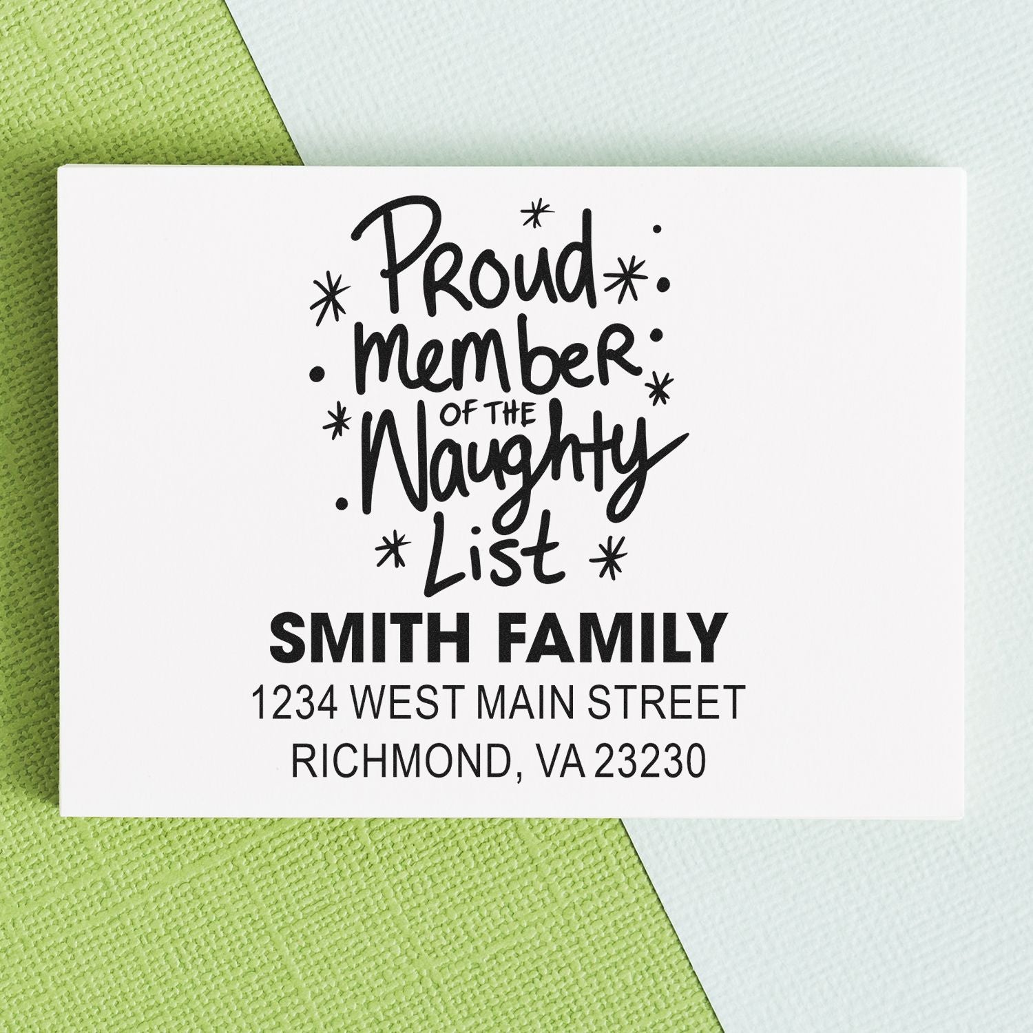 Personalized holiday address rubber stamp with Proud Member of the Naughty List for Smith family envelopes.
