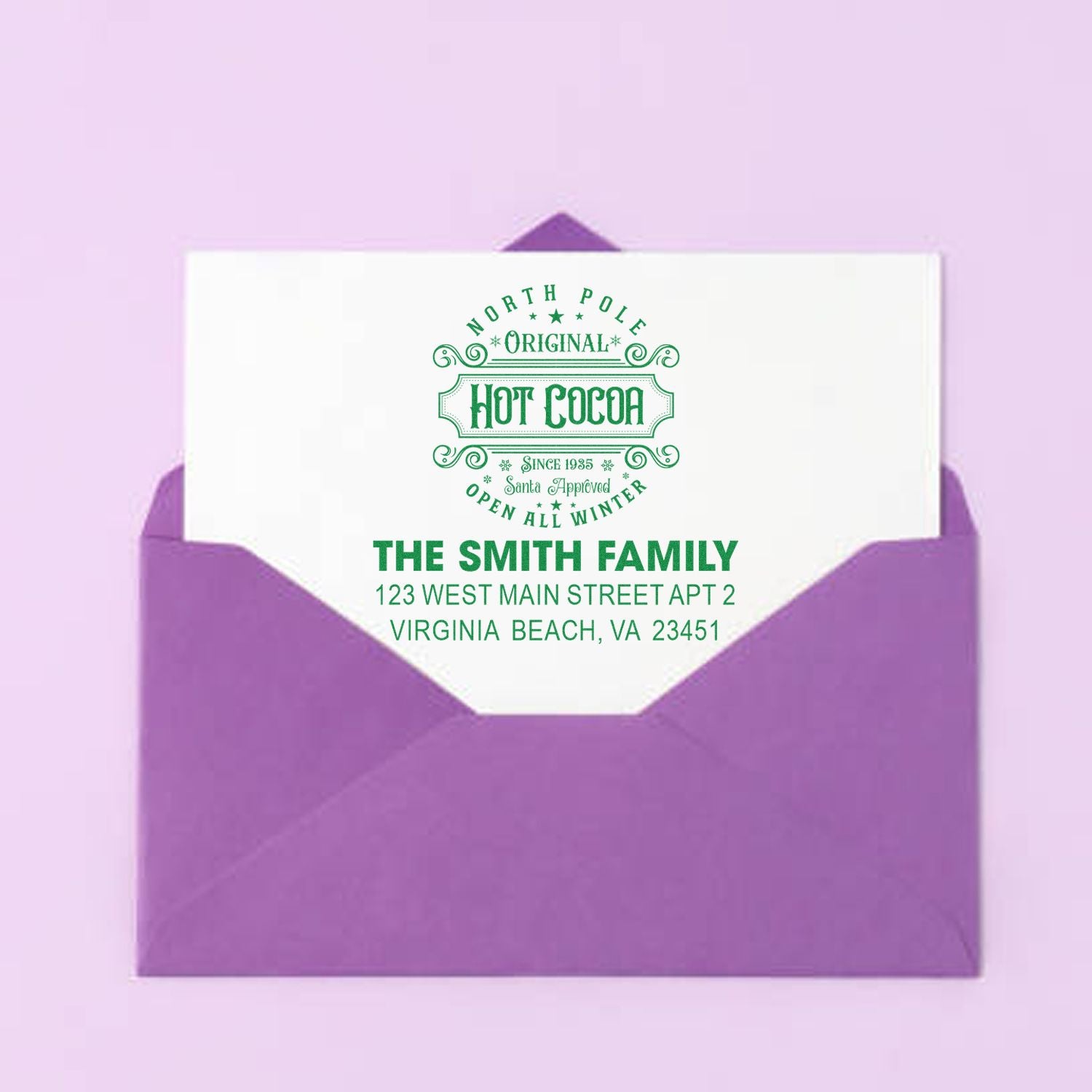 Custom hot cocoa return address rubber stamp for The Smith Family, featuring a festive winter design on a purple envelope.